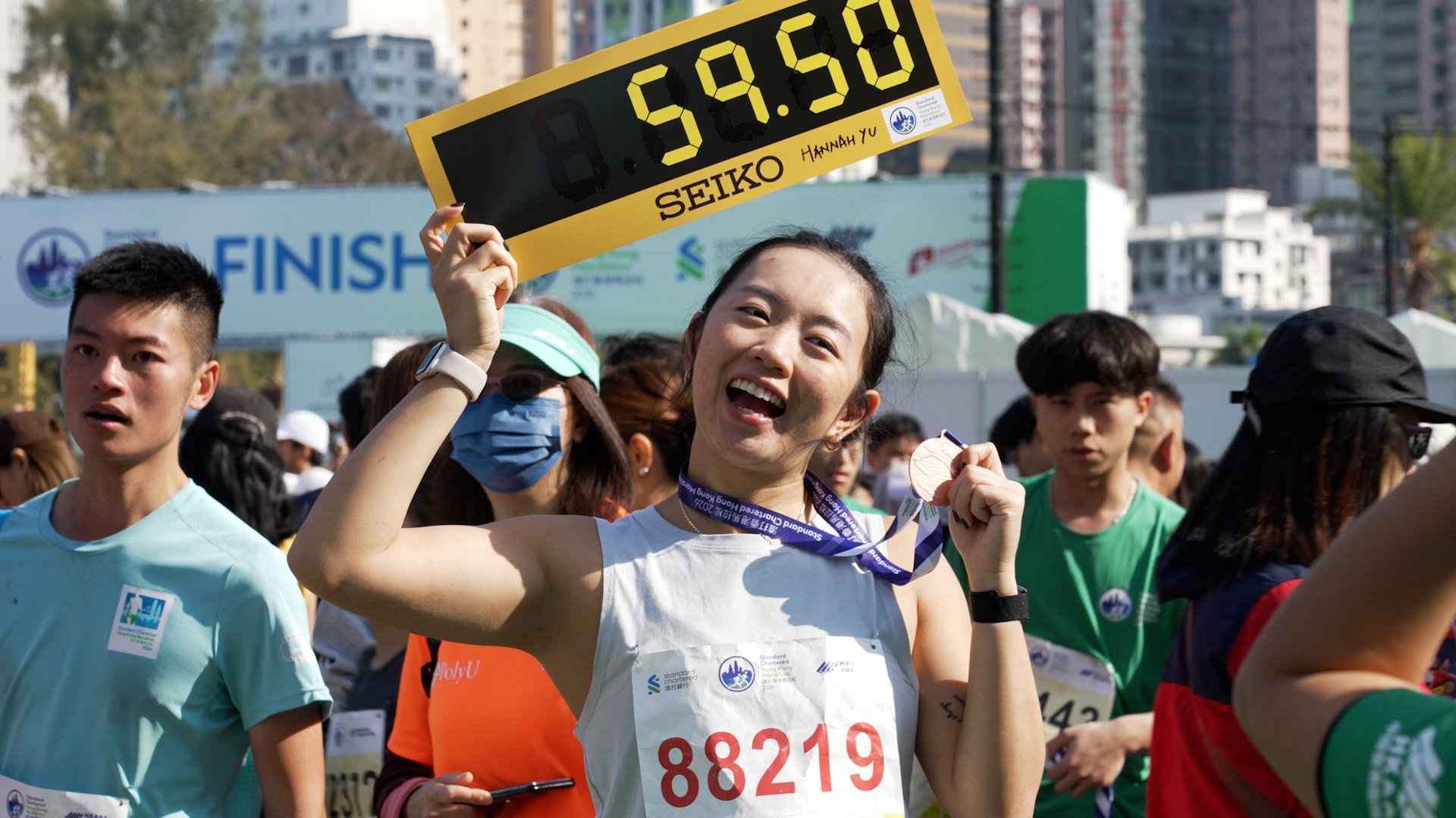 A runner showing her medal after completing her 10km race in the 2026 Hong Kong Marathon