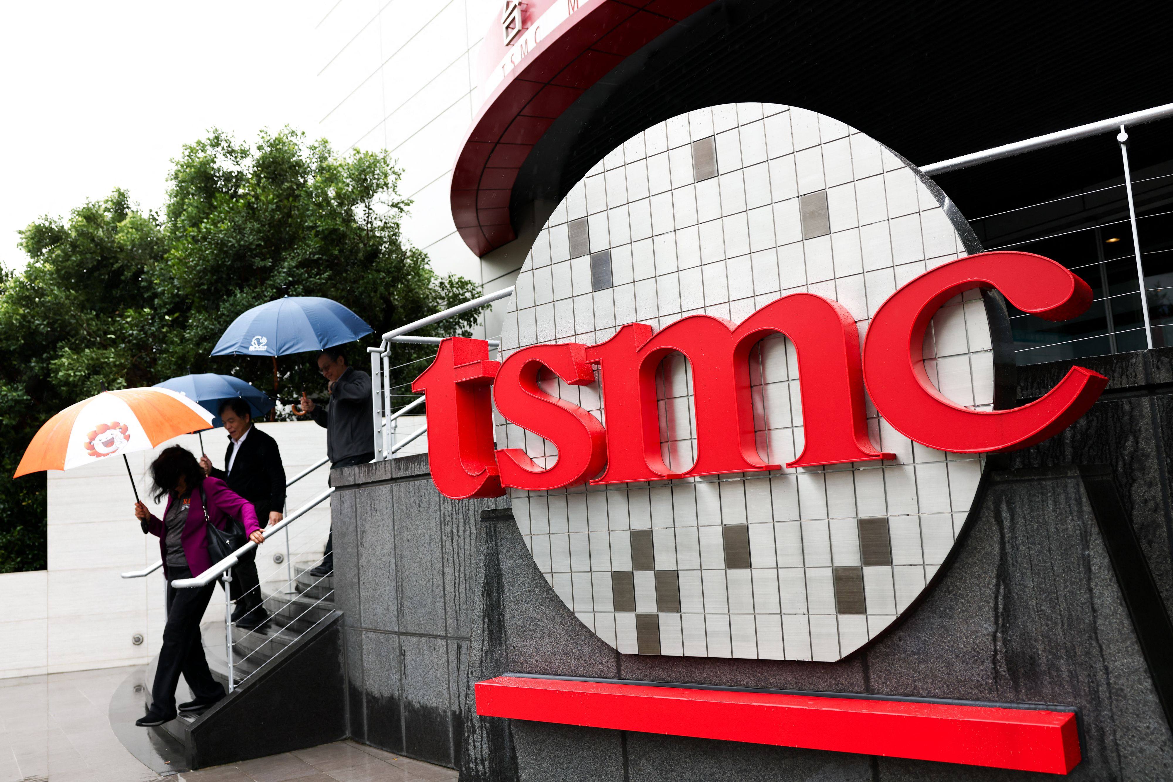 People walk beside a logo outside the Taiwan Semiconductor Manufacturing Company (TSMC) Museum of Innovation at its headquarters in Hsinchu on November 21, 2024. Photo: AFP