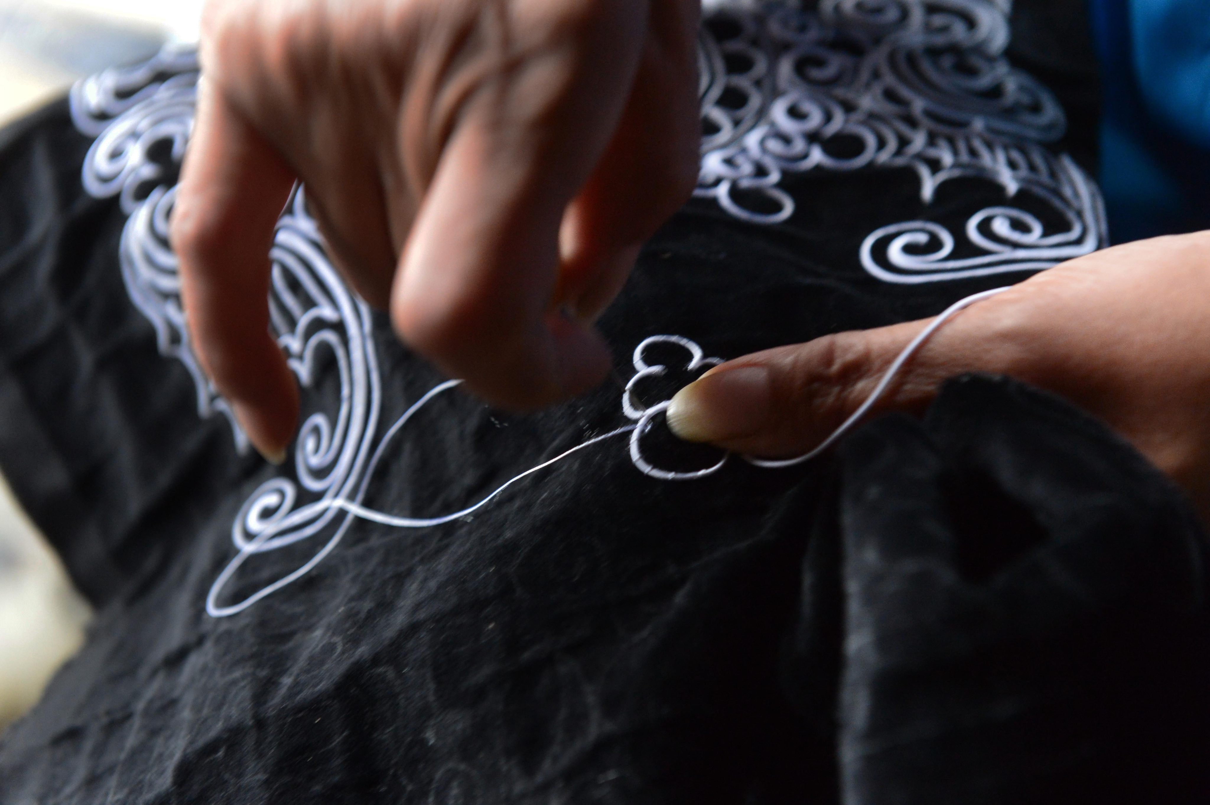 A Shui minority woman embroiders with horsetail in Sandu Shui Autonomous County in China’s Guizhou province. Shui minority women can spend months or even years making a piece of horsetail embroidery, which is used as decoration on clothes, shoes, wallets and more. Photo: Visual China Group via Getty Images