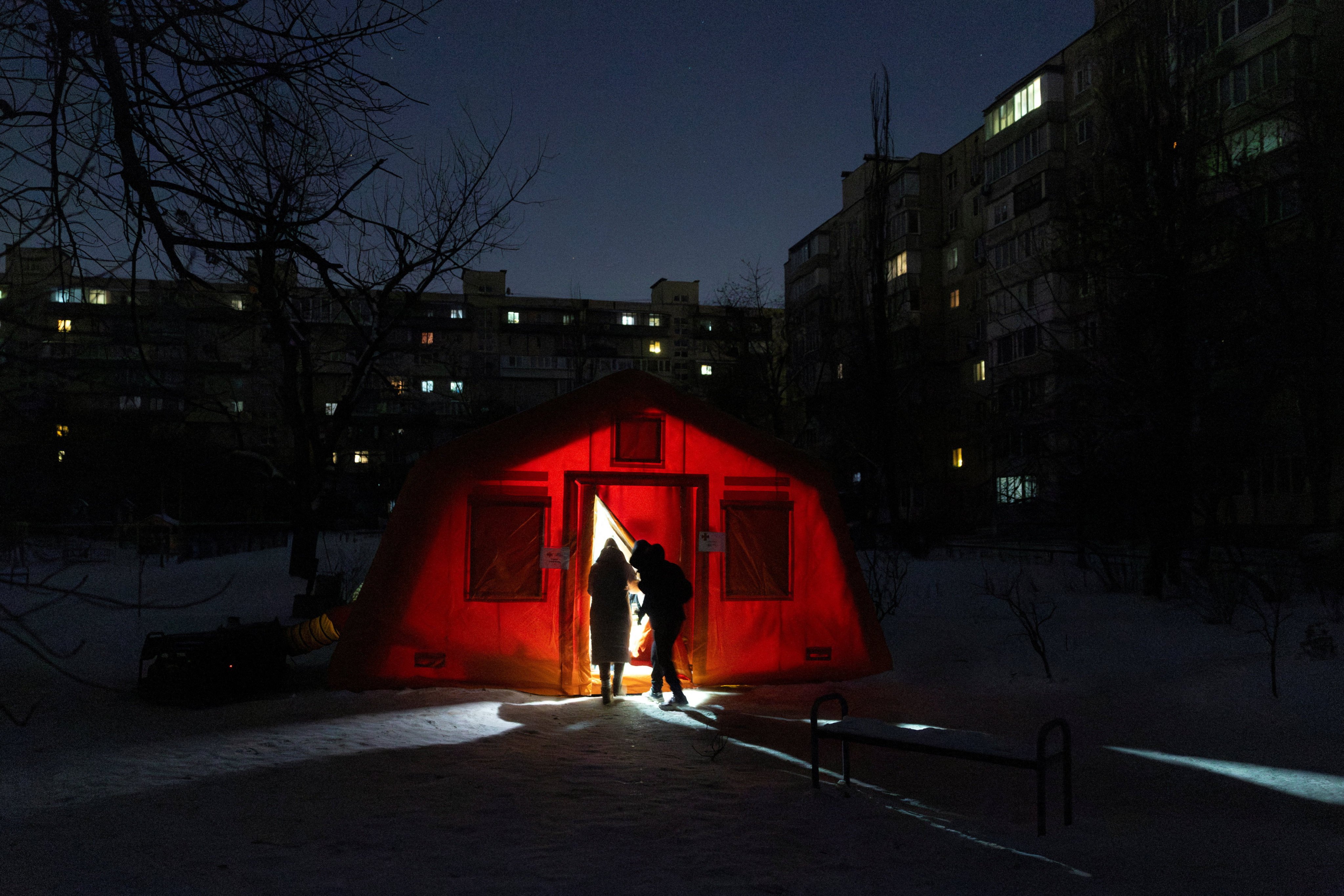 People enter a tent provided by emergency services for Kyiv residents whose homes have been left without heating during sub-zero temperatures. Photo: Reuters