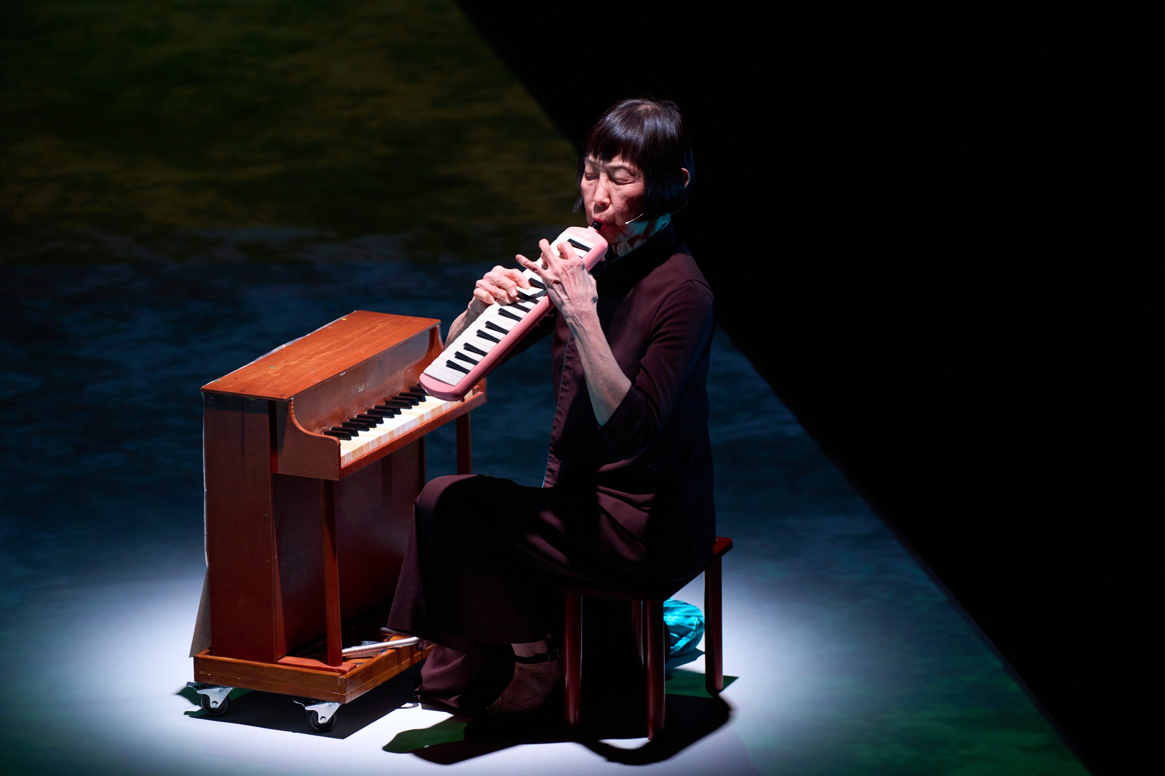 Margaret Leng Tan plays a melodica during a recent performance of “Dragon Ladies Don’t Weep” in Hong Kong. The production, which combines spoken word, projected images and toy piano music, is an autobiographical portrait of a musician living with obsessive-compulsive disorder. Photo: Visual Voices, courtesy of West Kowloon Cultural District Authority