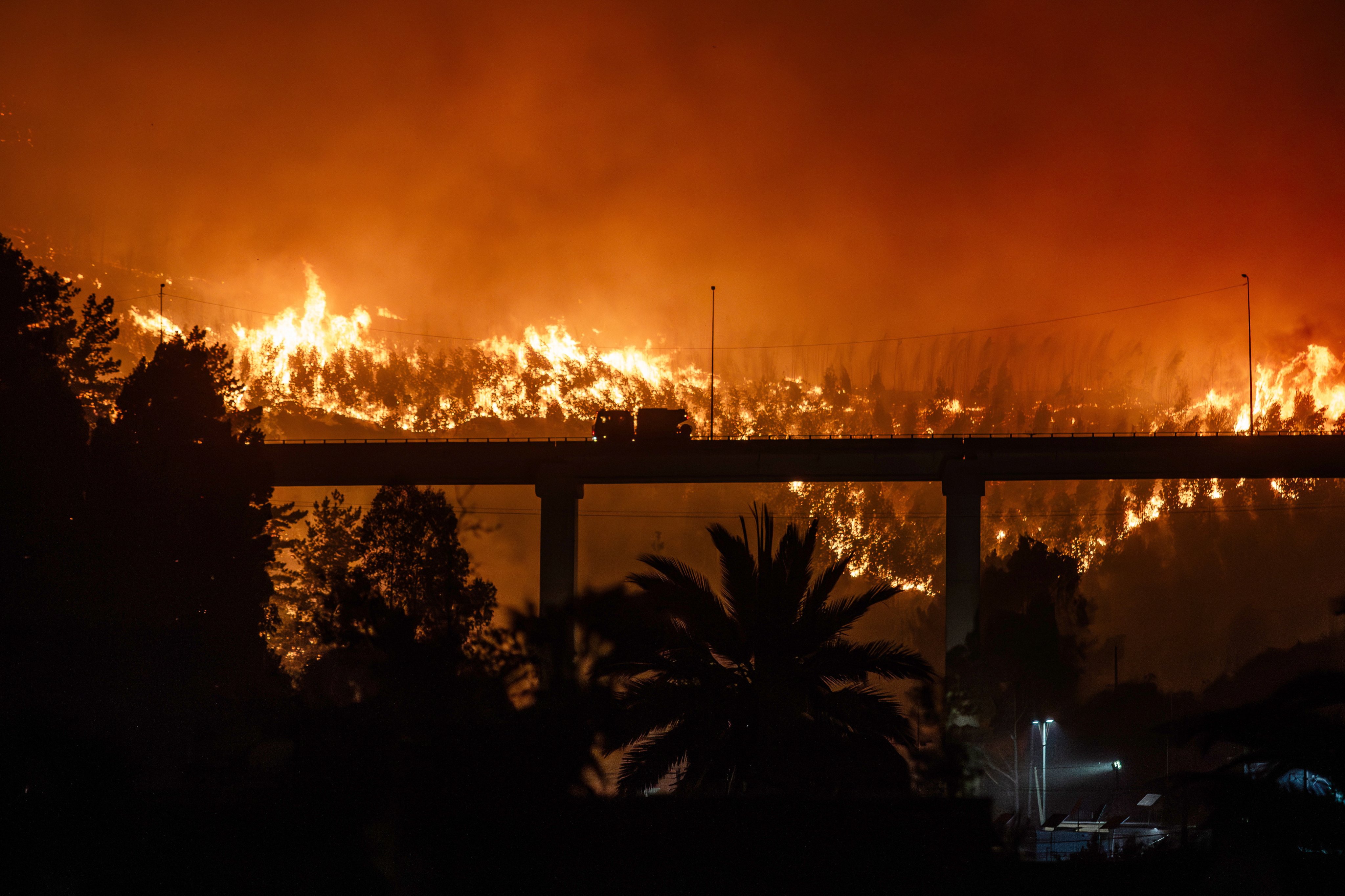 A fire burns in Penco, Chile on Sunday. A total of 18 people have died in several wildfires that are still burning in southern Chile. Photo: EPA