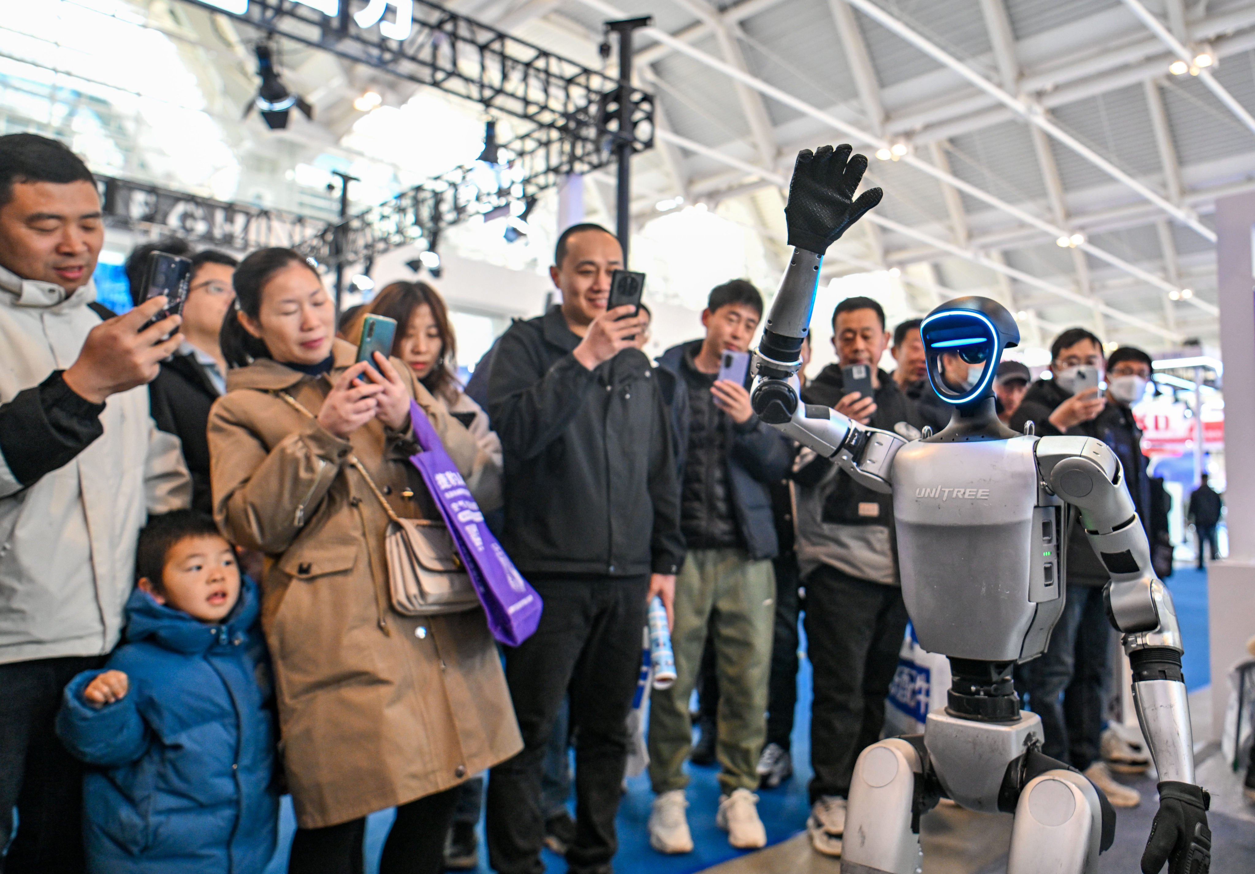 A G1 humanoid robot model from Unitree waves at visitors during the 21st China International Equipment & Manufacturing Industry Expo in Tianjin on March 6, 2025. Photo: Xinhua