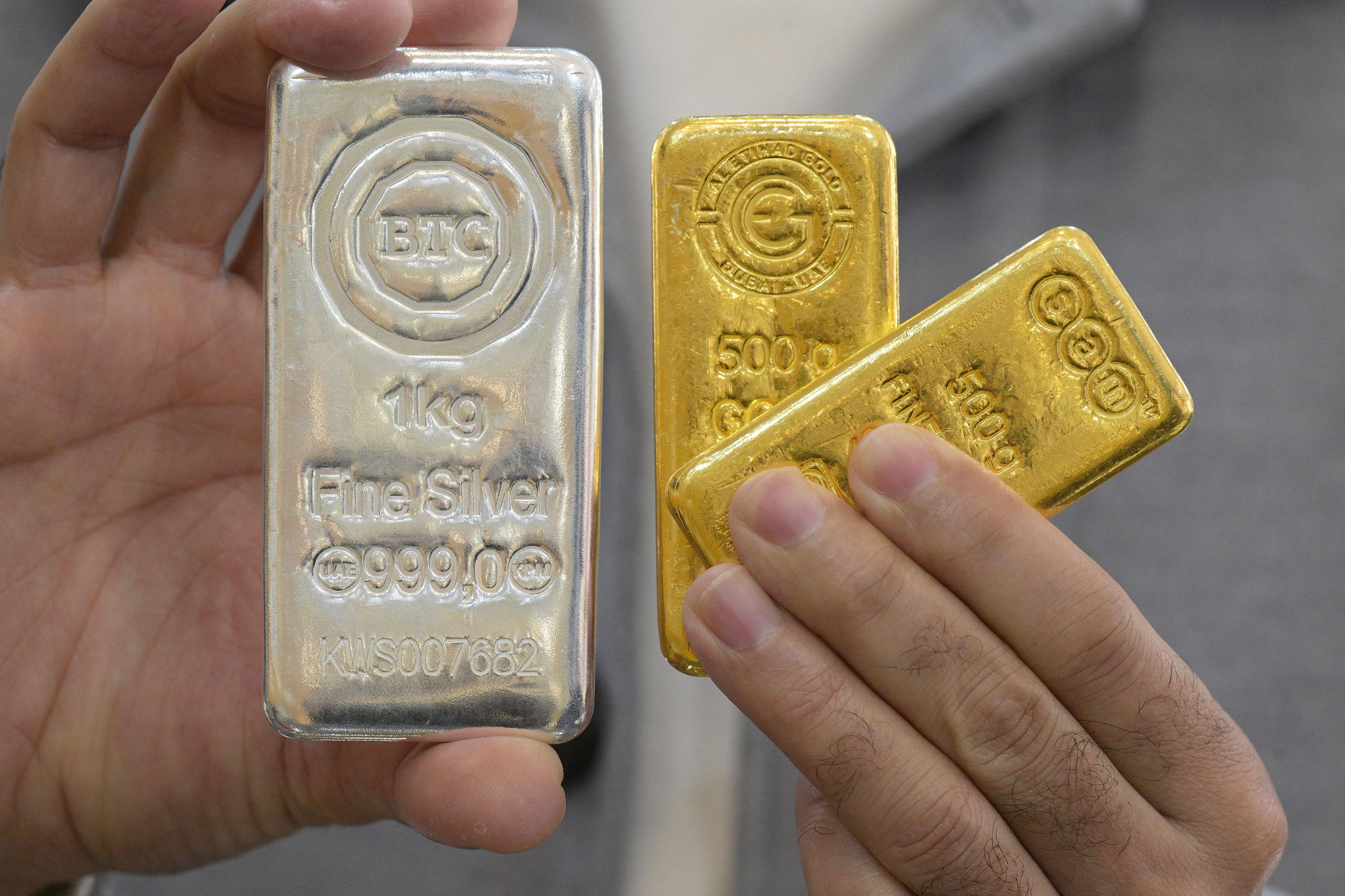 A jeweller displays gold and silver bars at his Kuwait City shop on January 12. Precious metal prices hit records amid market volatility and US trade tension fears. Photo: AFP
