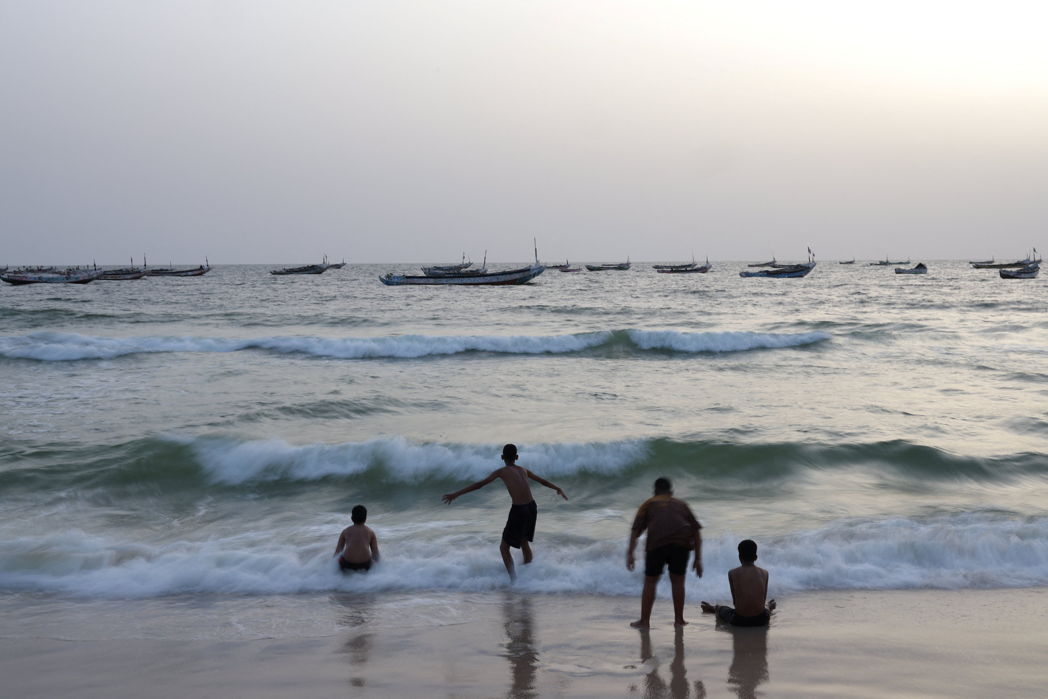 Young people enjoy the waves on a beach near the Nouakchott Artisanal Port in Mauritania on July 17 last year. The UN projects that the world population will grow to 11.2 billion by 2100. Photo: Reuters