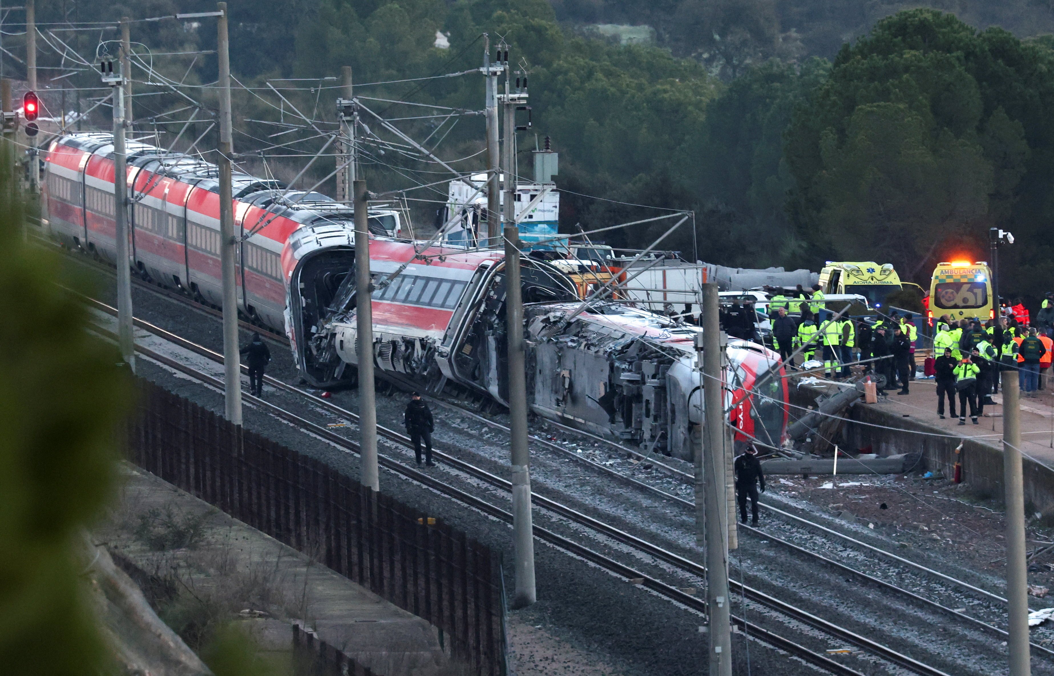Members of the Spanish Civil Guard, along with other emergency personnel, work next to one of the trains involved in the crash. Photo: Reuters
