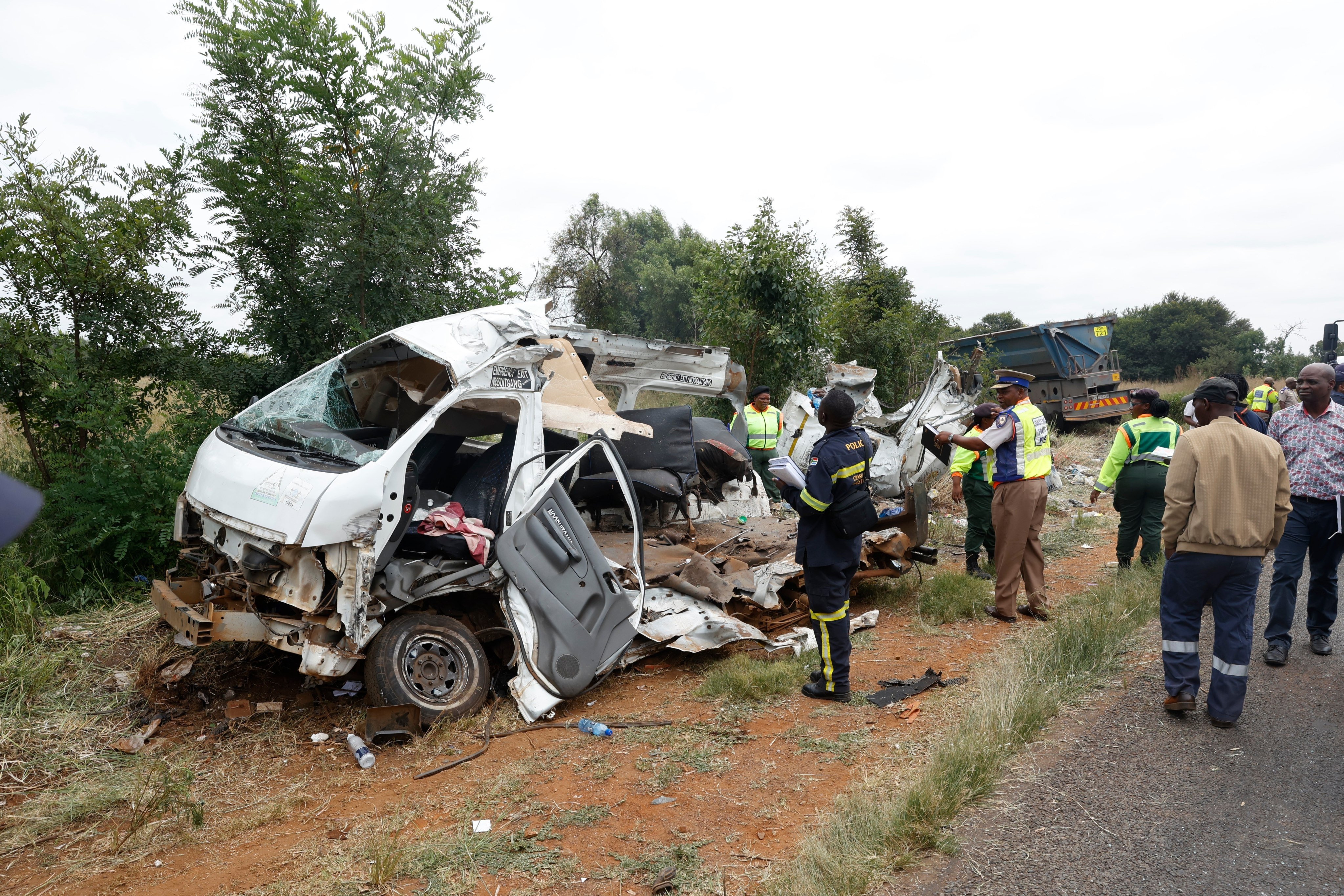 Police inspect the scene of a collision between a truck and a minibus near Johannesburg, South Africa on Monday. Photo: AP