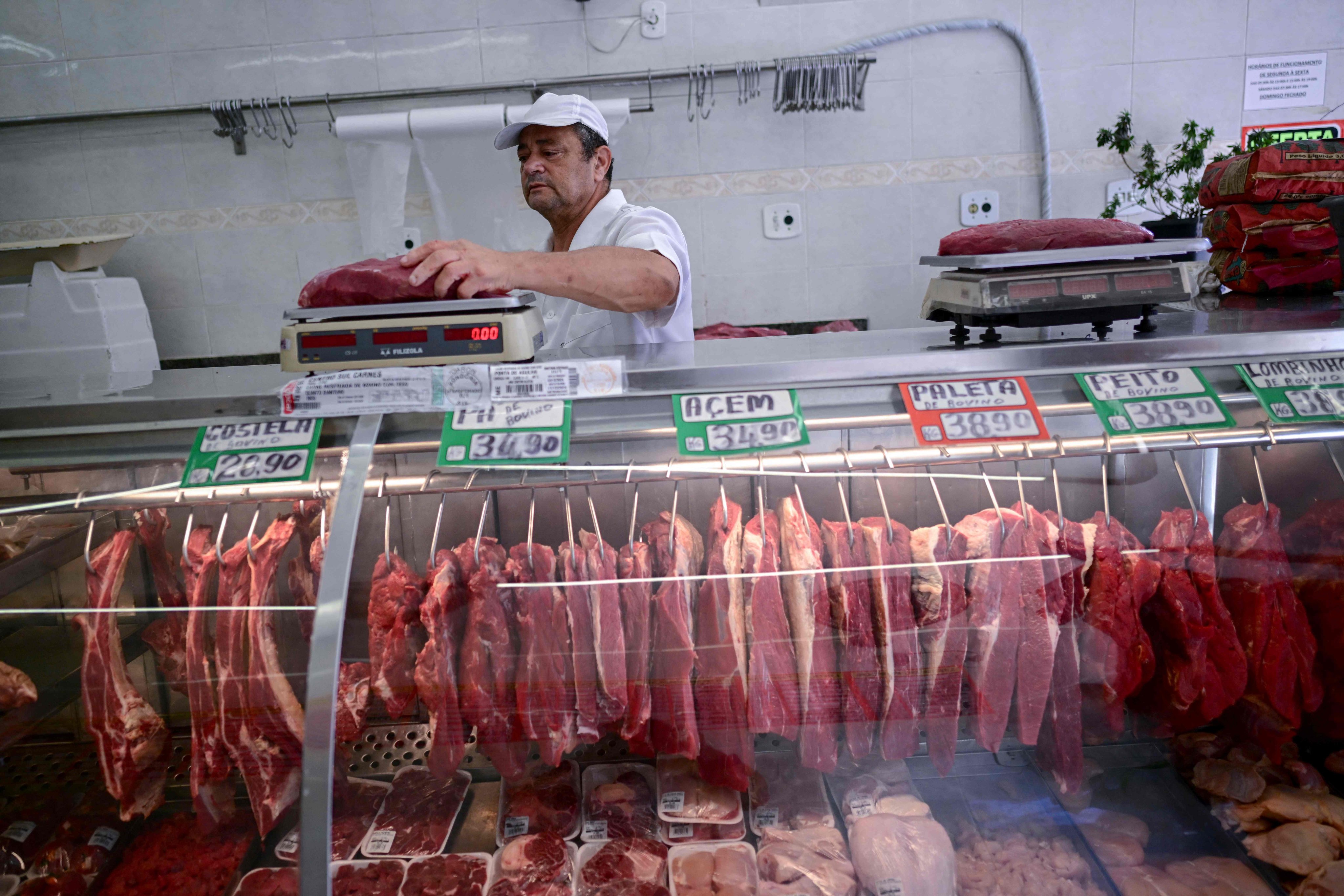 A butcher weighs meat at a butcher shop in Rio de Janeiro, Brazil in 2024. Photo: AFP
