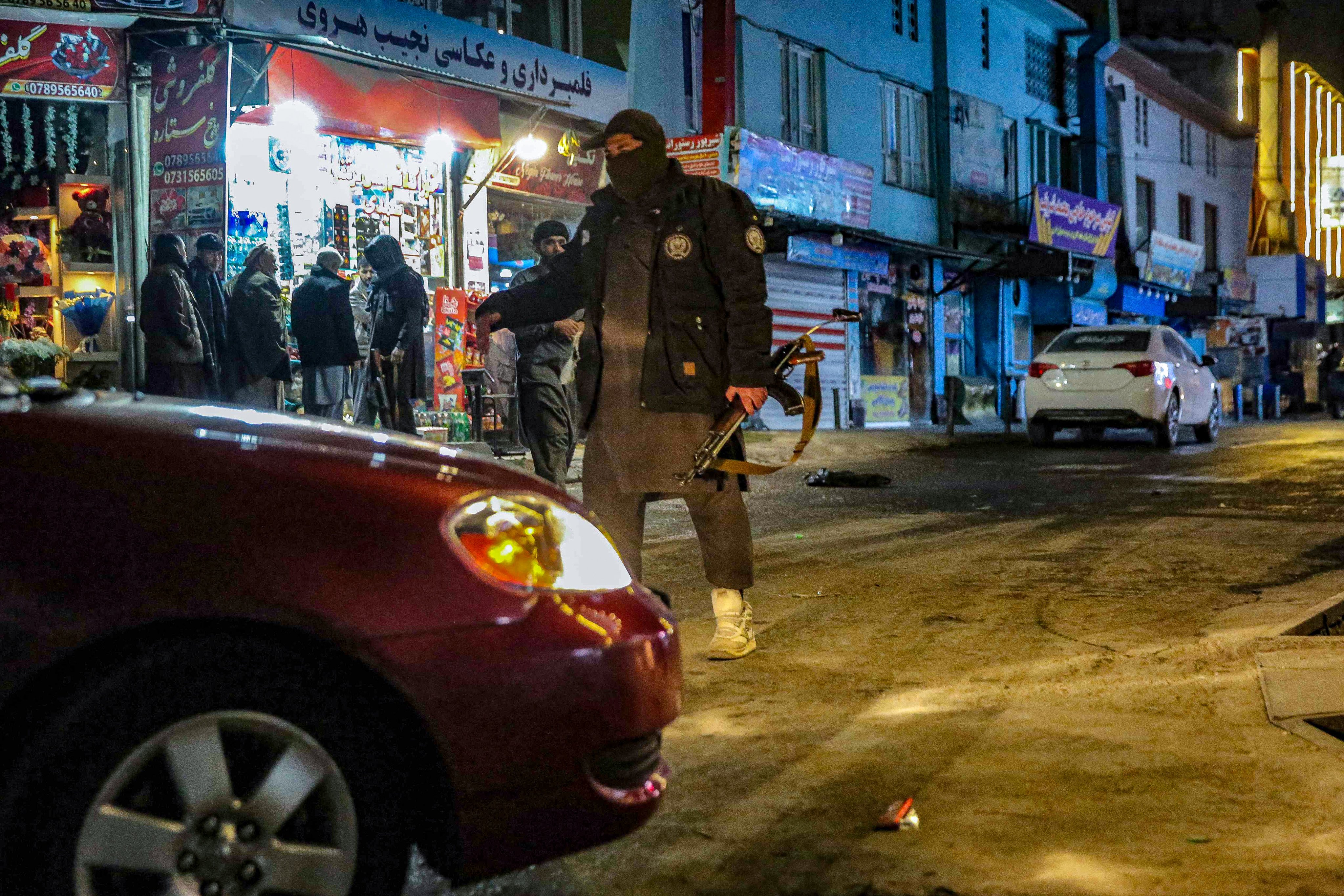 Taliban security personnel stand guard at the scene of the attack in Kabul. Photo: AFP
