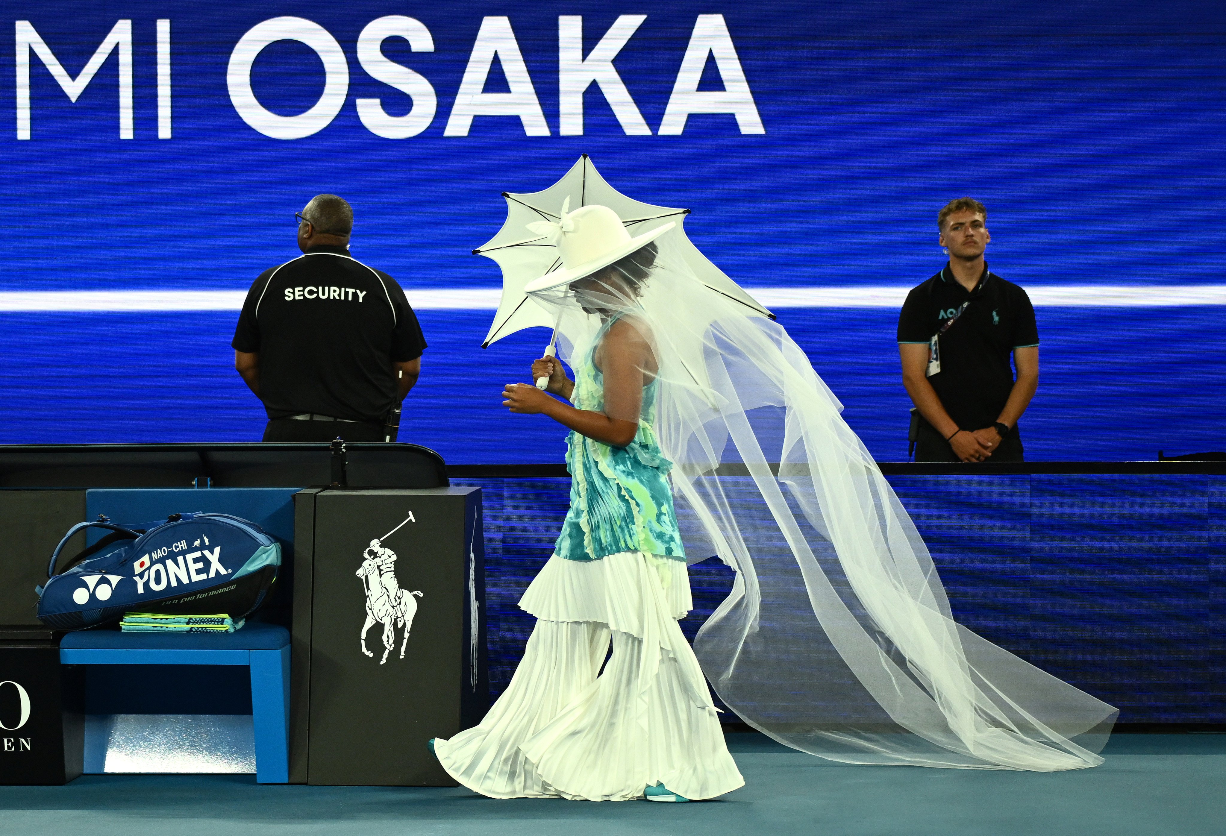 Former world number one Naomi Osaka emerged at Rod Laver Arena clutching a white parasol and wearing a matching wide-brimmed hat and veil. Photo: dpa