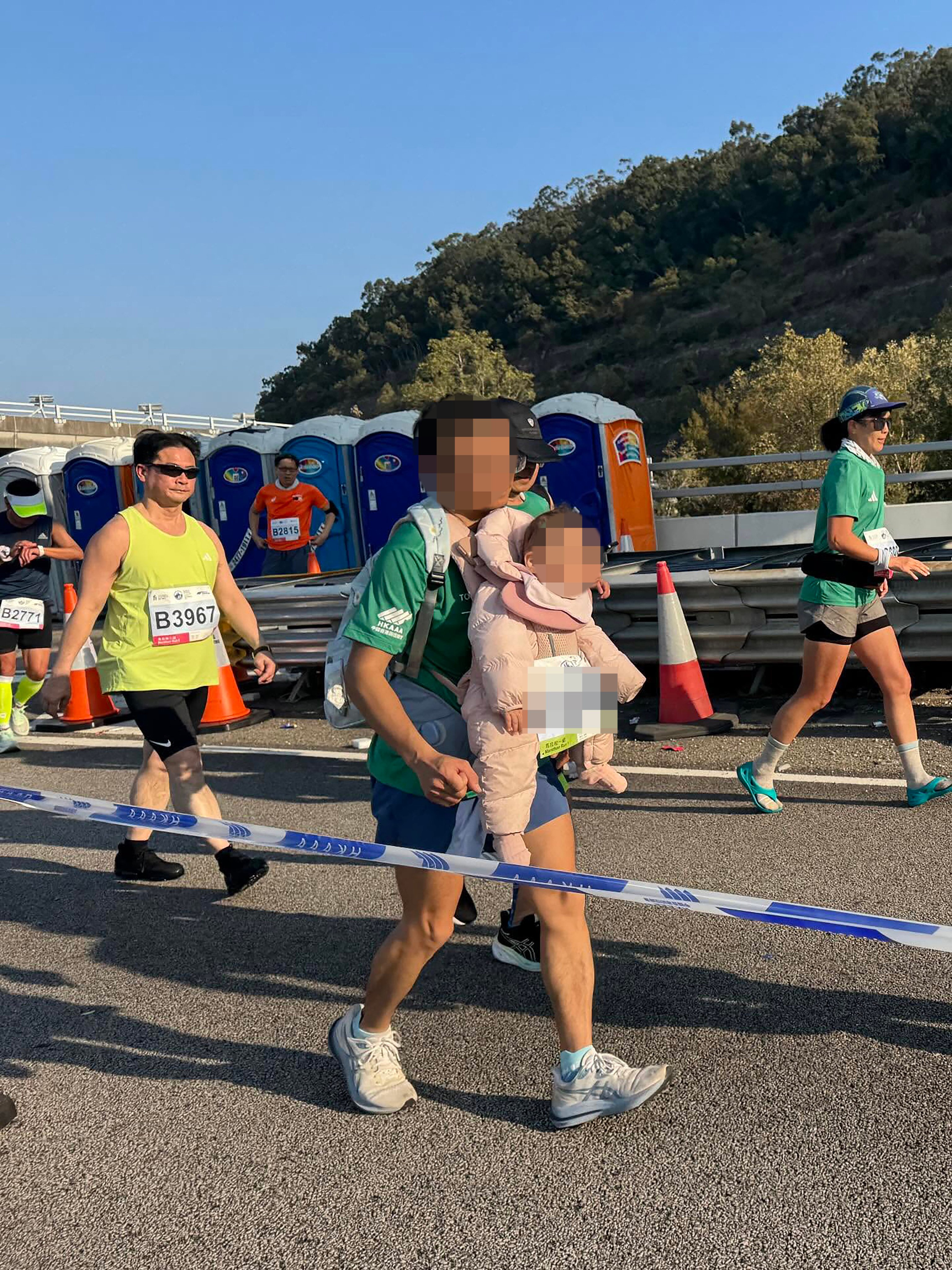 A participant in the 2026 Standard Chartered Hong Kong Marathon last Sunday sparked online discussion after being spotted carrying a baby while running, raising serious safety concerns. Photo: handout