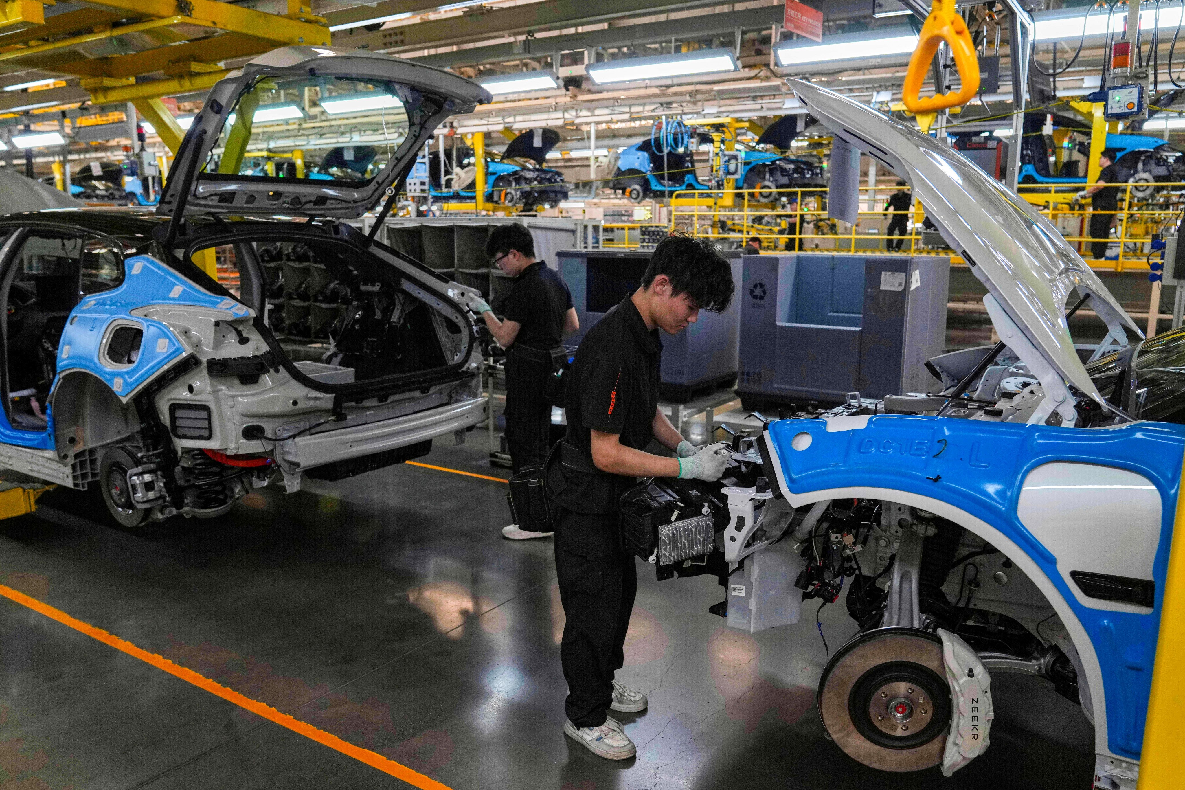 Workers assemble Zeekr models at a plant in Ningbo, Zhejiang province, on April 17, 2025. Photo: AP