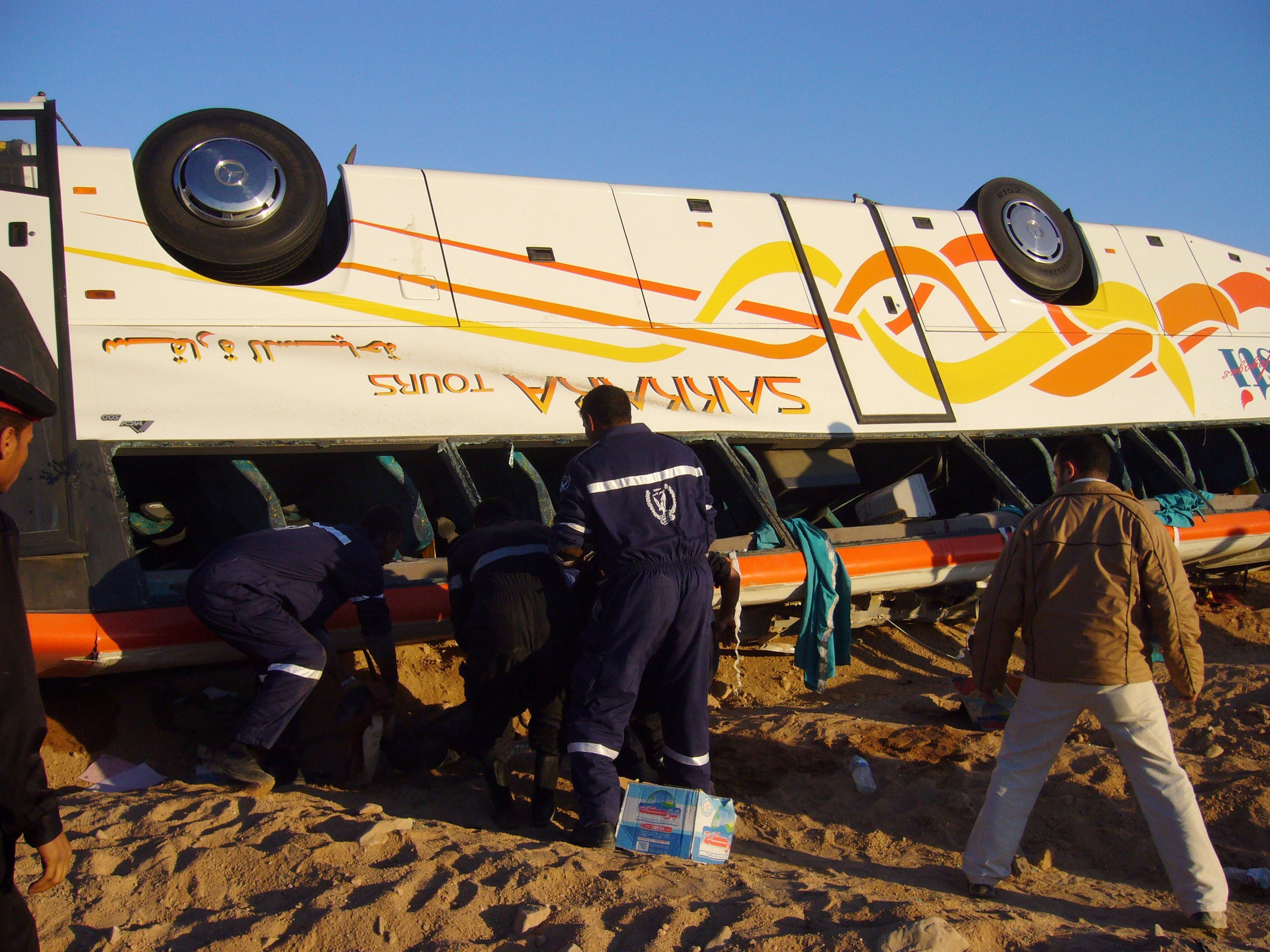 Emergency responders look for survivors inside a toppled bus carrying Hong Kong tourists on January 31, 2006. File photo: Handout