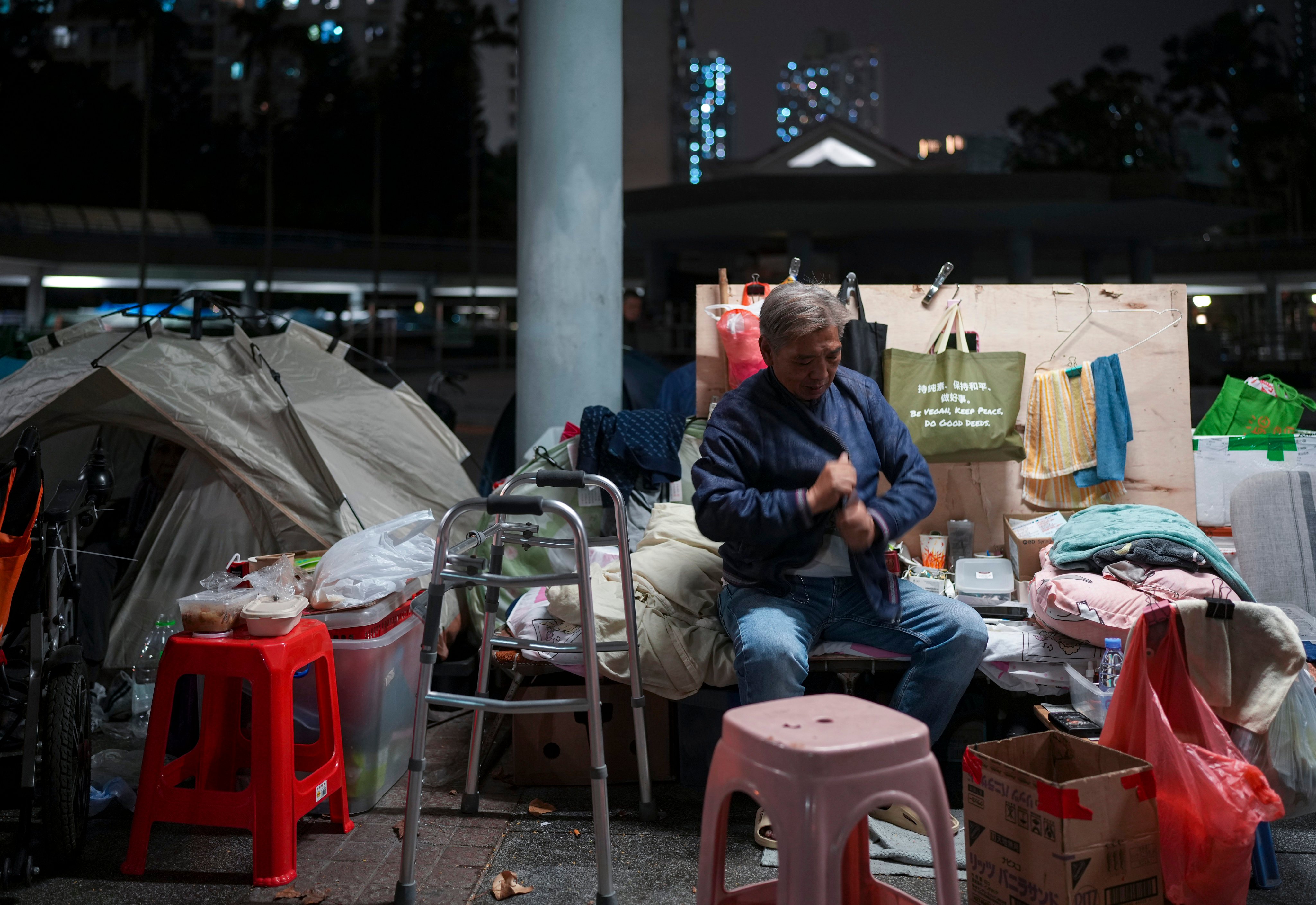 Henry Lai has a wooden board next to his bed to guard against the bitter wind. Photo: Sam Tsang