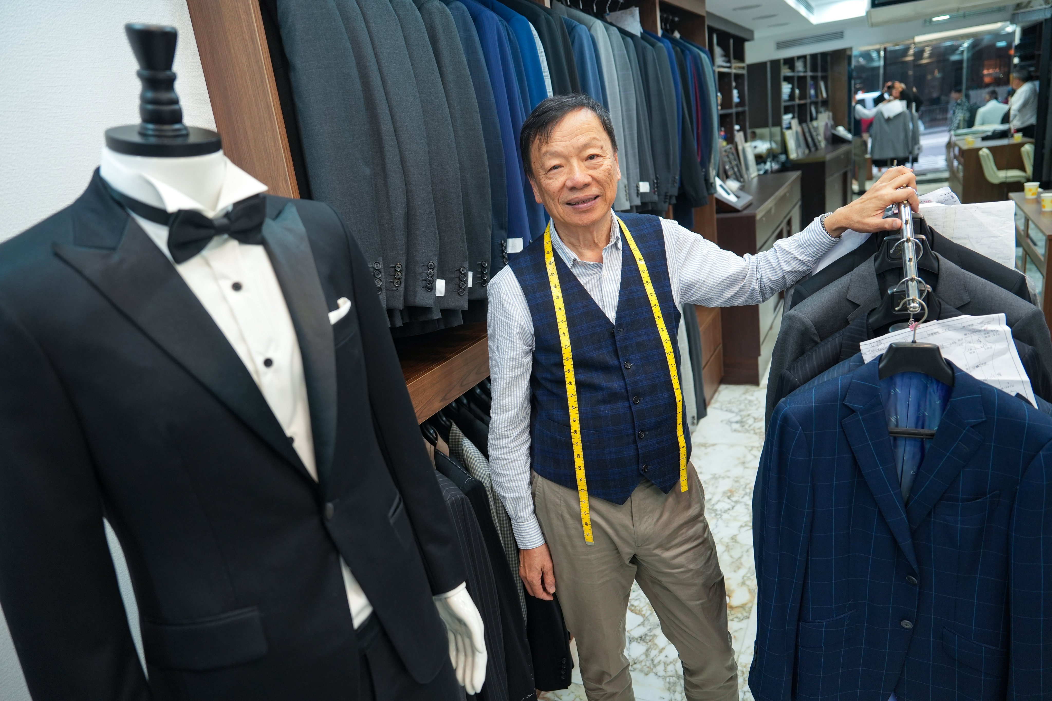 Master Woo, tailor and owner of Benny Woo Sartorial, poses for a portrait in his shop in Central. Photo: Sun Yeung