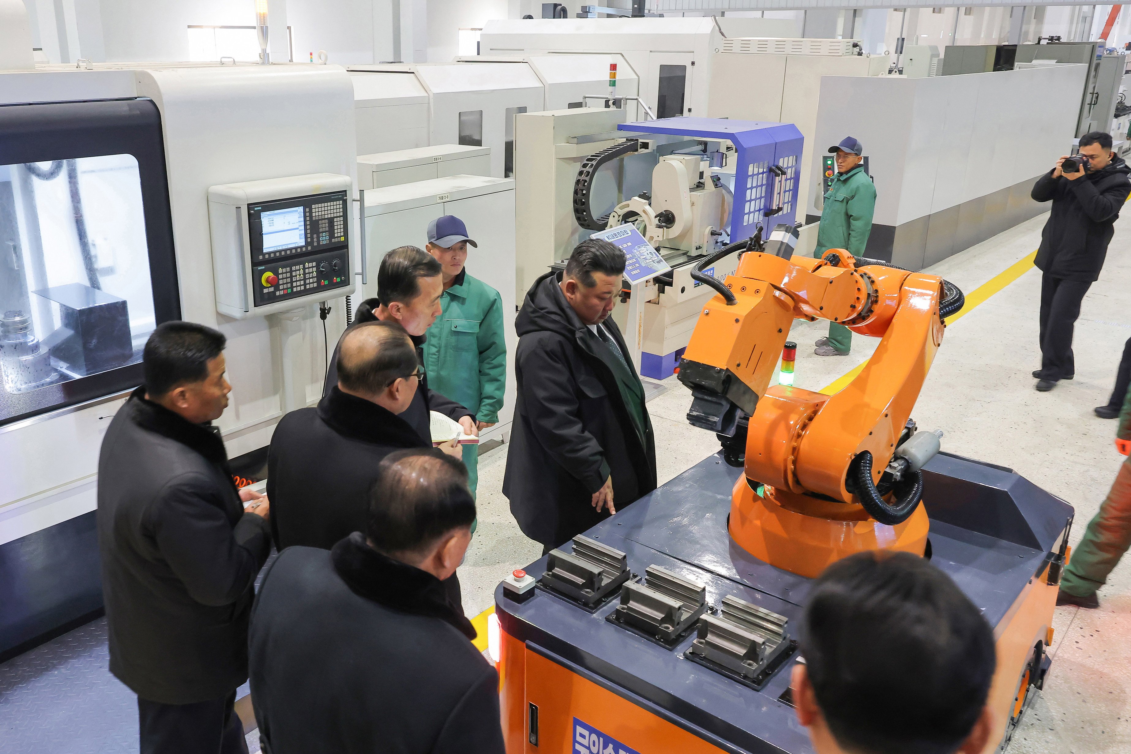 North Korean leader Kim Jong-un  looks at a robot during a  ceremony to mark the completion of the first phase of Ryongsong Machine Complex’s modernisation on Monday. Photo: KCNA/dpa