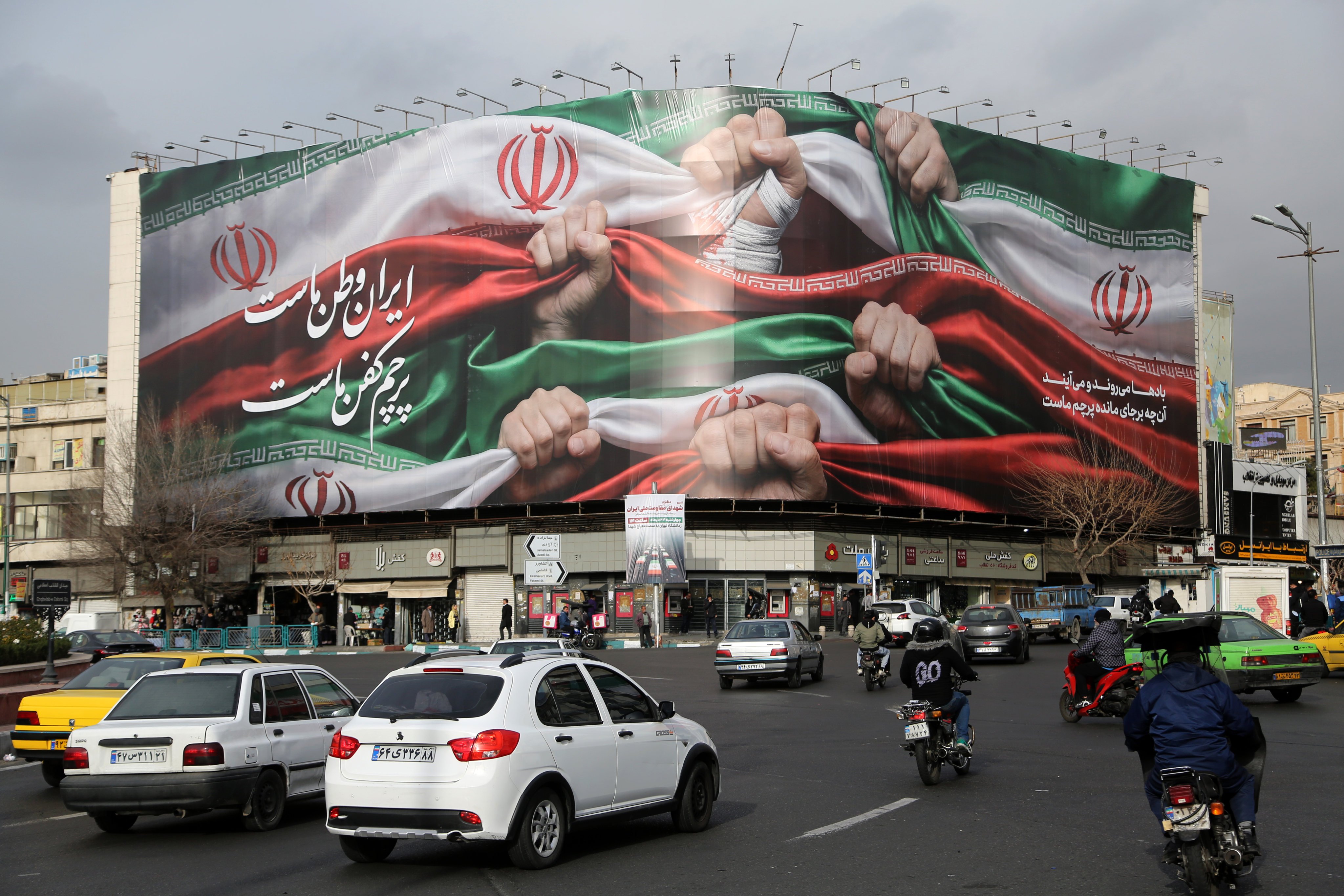 A giant banner hangs over Enghelab Square in central Tehran as Iran faces threats of US intervention following a brutal crackdown on nationwide economic protests. Photo: Xinhua