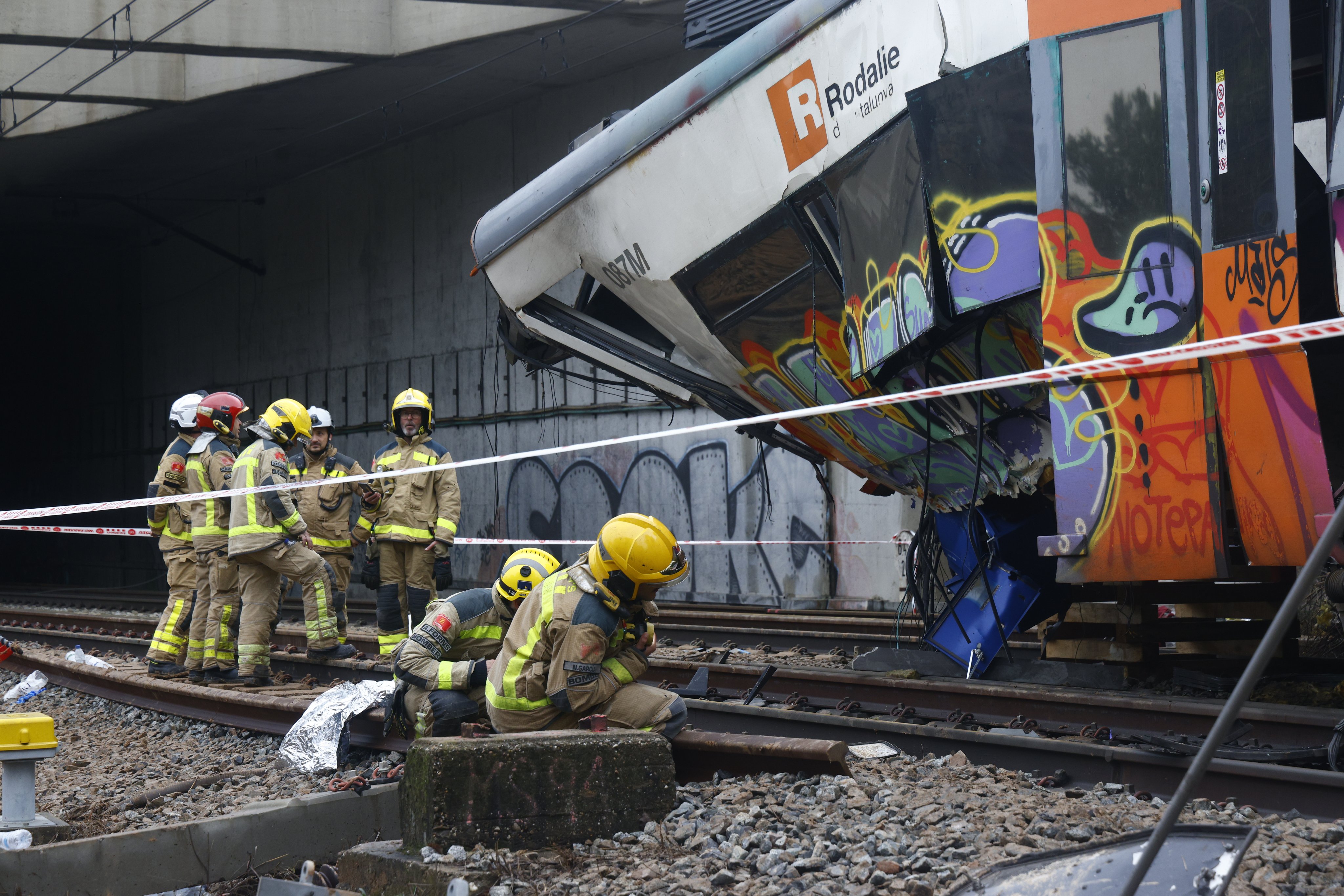 Rescuers on Wednesday inspect a commuter train that derailed near Barcelona, Spain. Photo: EPA