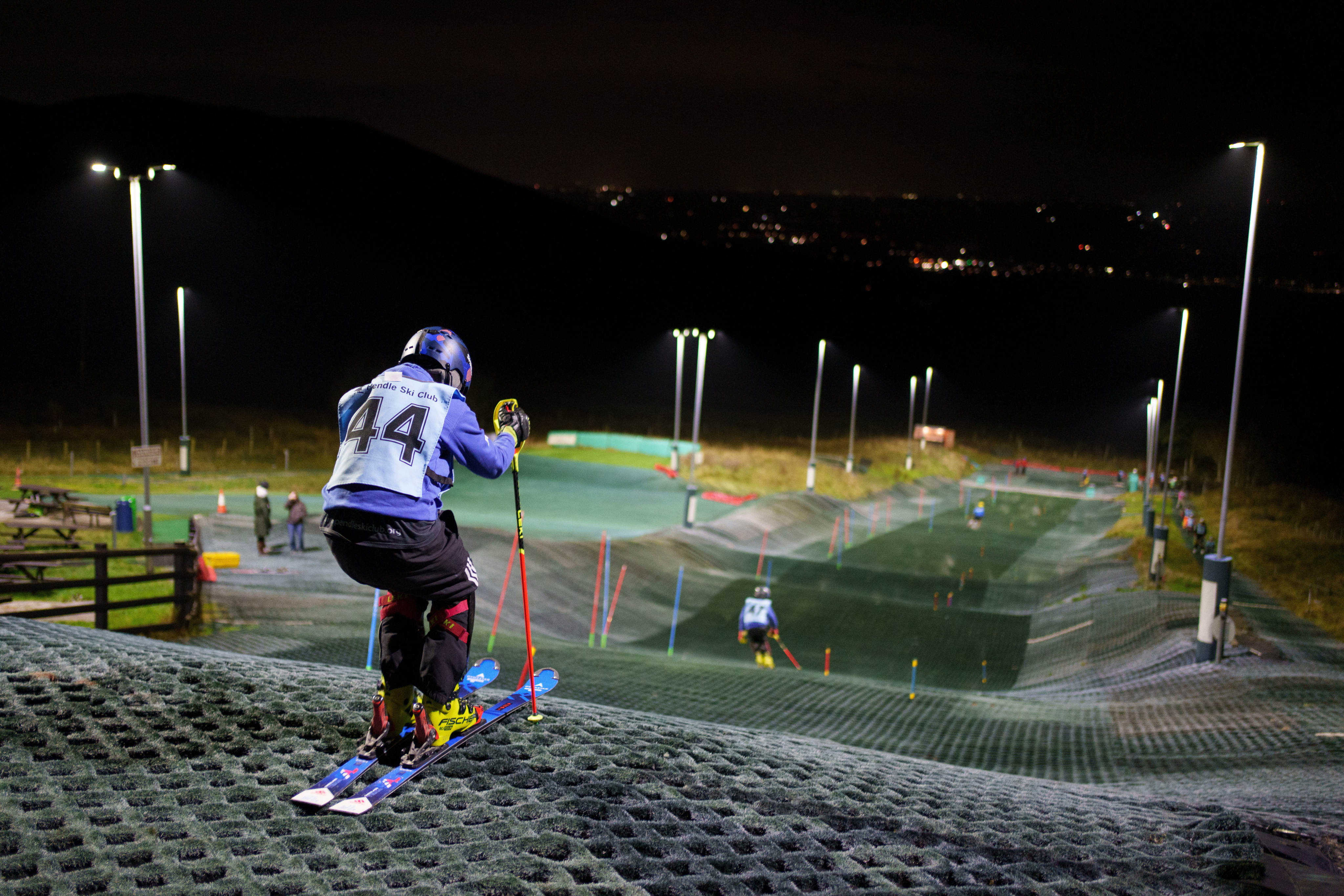 Competitors warm up before an inter-club ski meeting at Pendle Ski Club in Clitheroe, England. Photo: AP