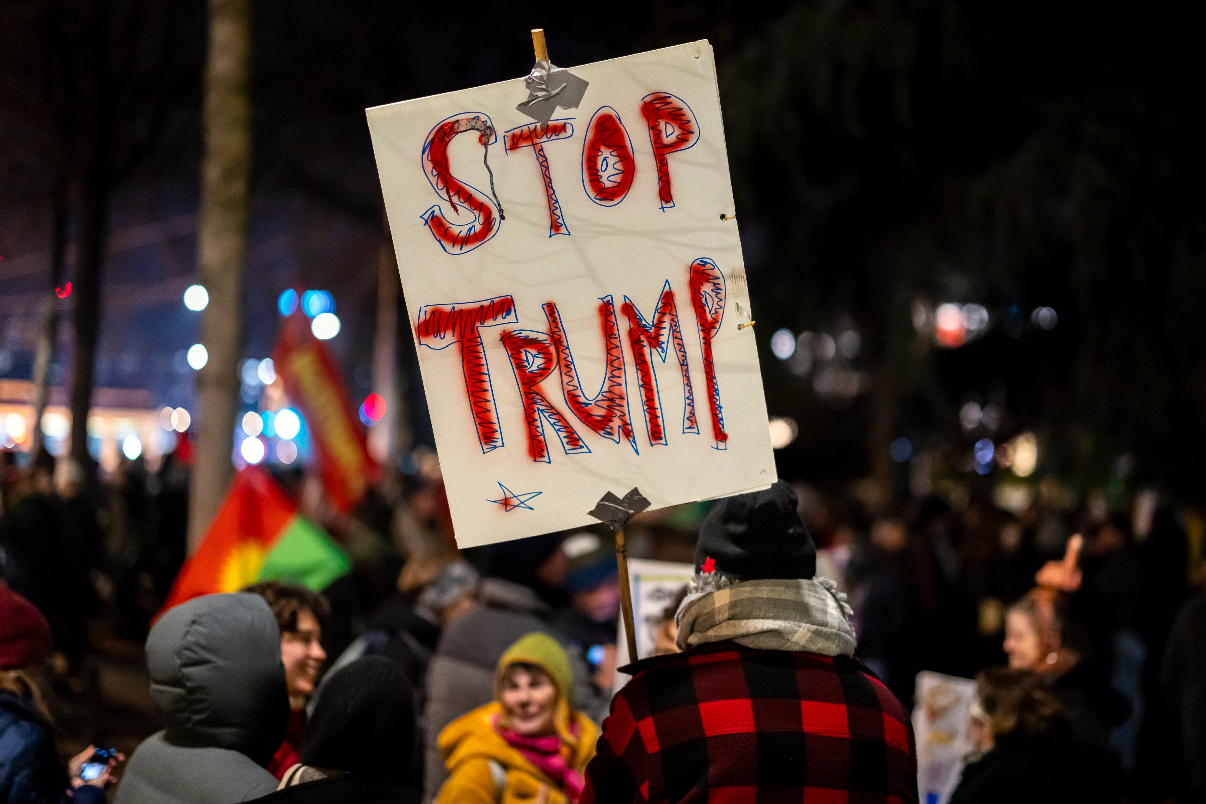 A protester holds a placard reading ‘Stop Trump’ during a rally in Zurich, Switzerland, on Monday, before the World Economic Forum meeting in Davos. Photo: EPA