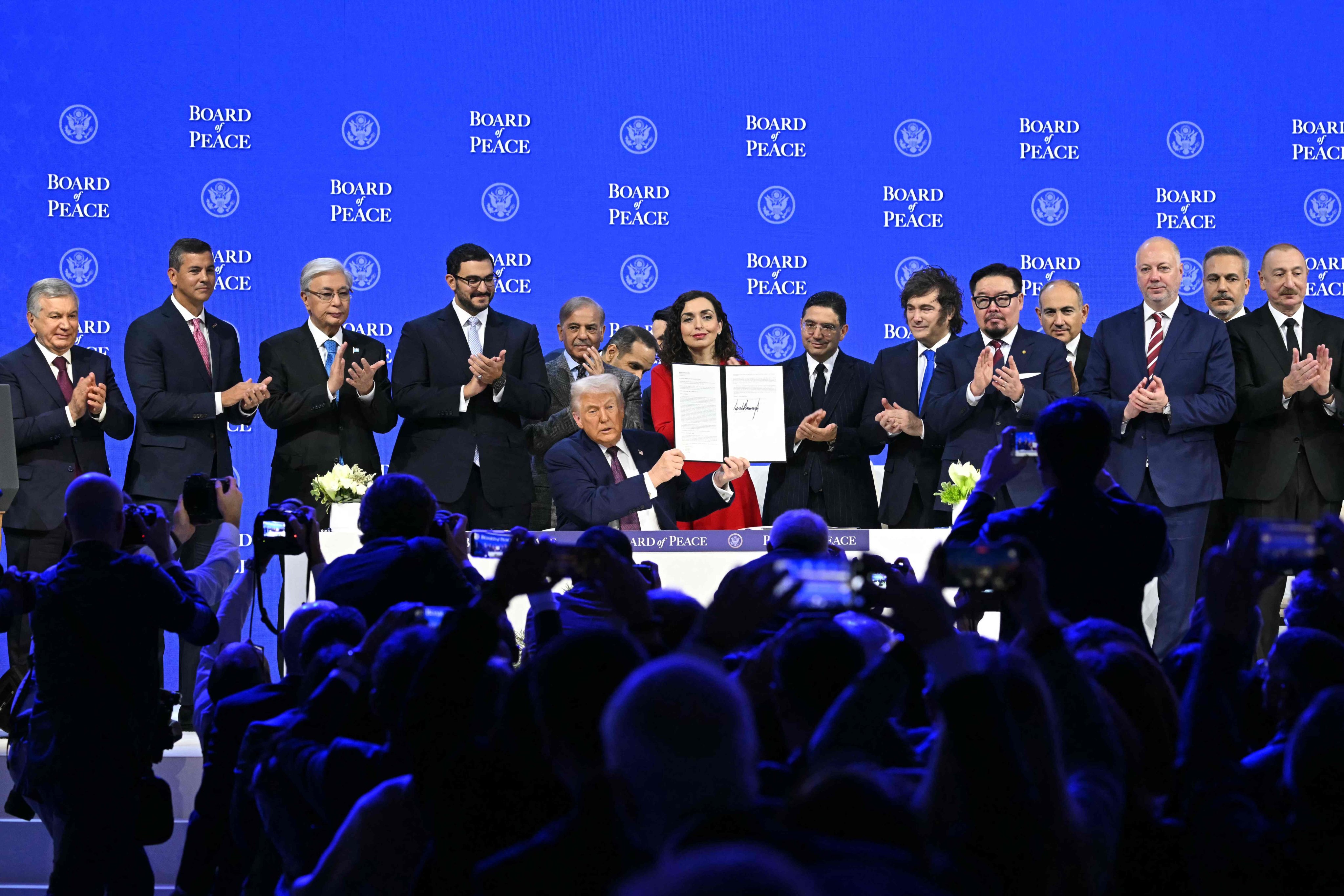 US President Donald Trump holding a signed founding charter with leaders and representatives from other countries. Photo: AFP