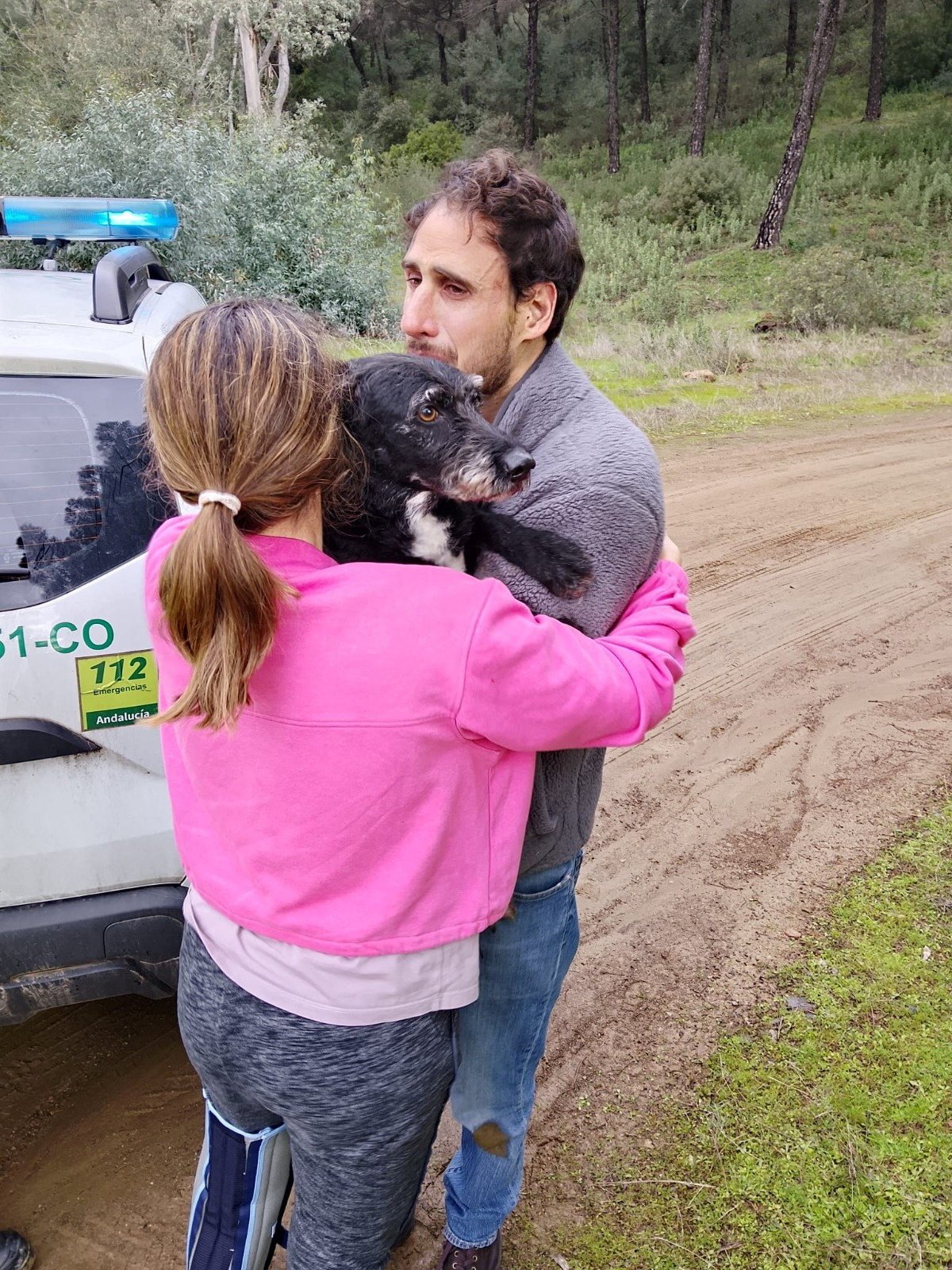 Ana Garcia hugs Boro on Thursday after the dog was rescued by Andalusia regional firefighters. Photo: Plan Infoca via Reuters