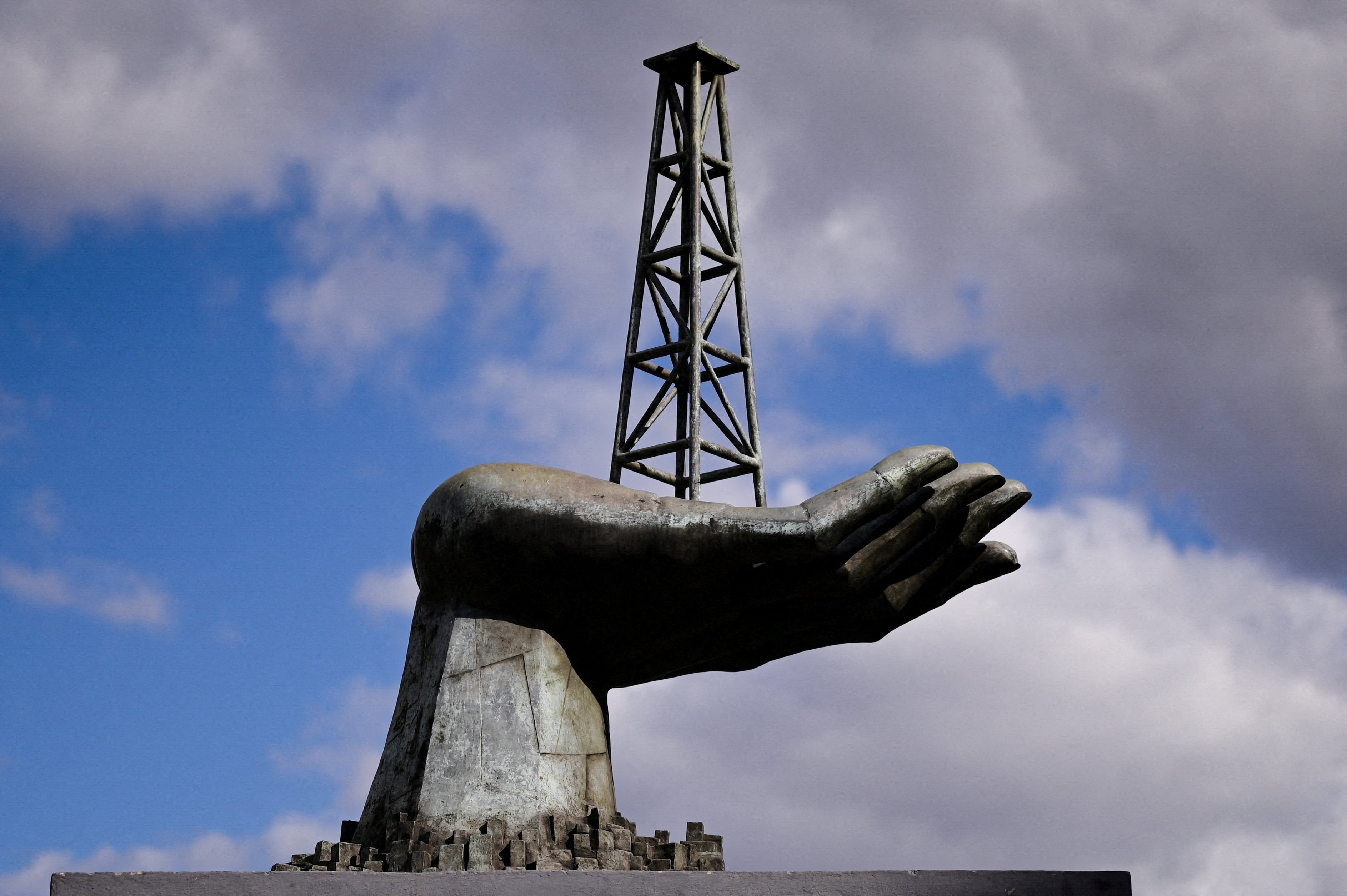 A statue of a hand holding an oil well tower stands near the headquarters of Venezuela’s state-run oil company PDVSA in Caracas, Venezuela, on January 13. Photo: Reuters