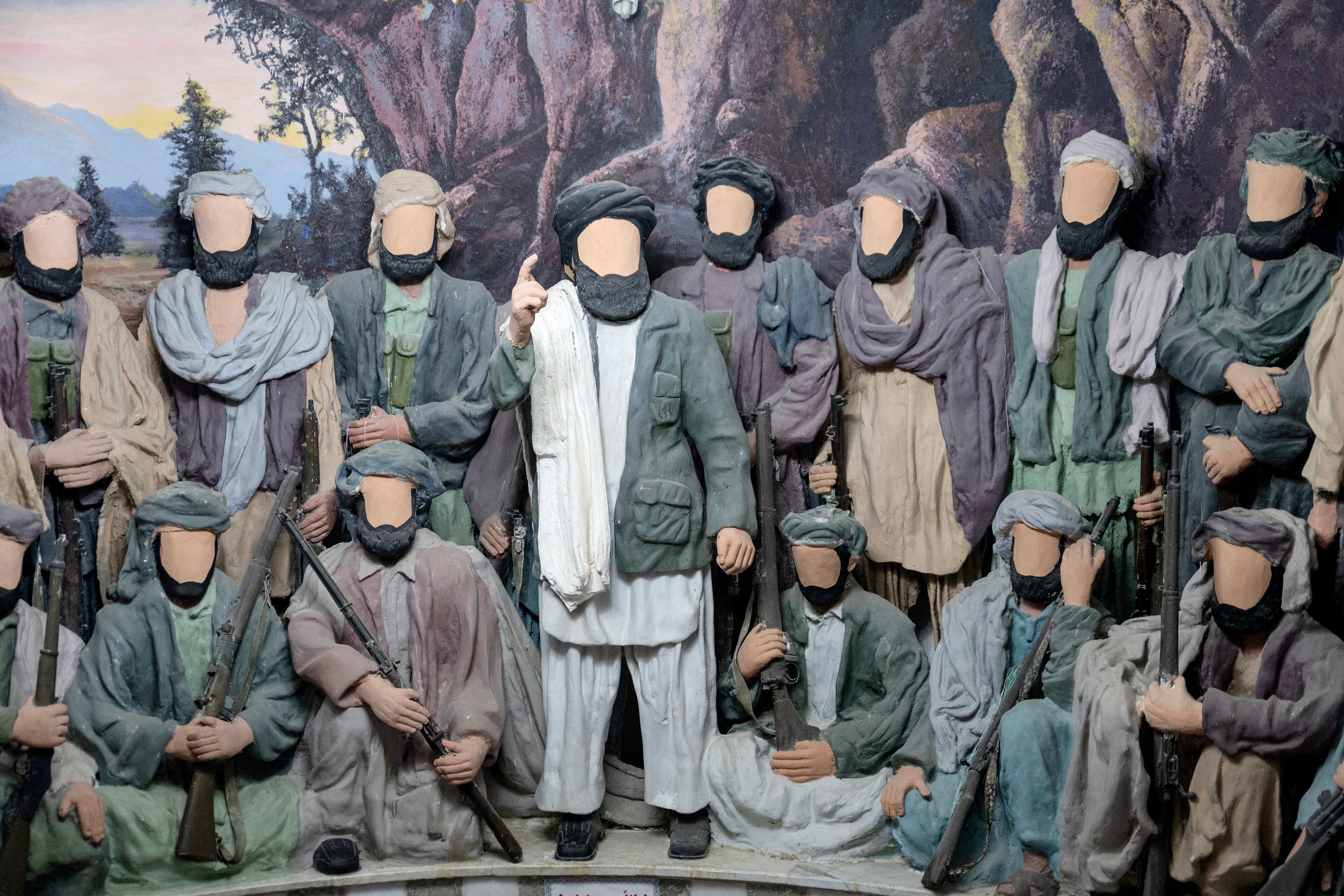 This photograph taken on January 6, 2026 shows a diorama depicting the Afghan resistance to the Soviet invasion of 1979, with figurines of Afghan mujahideen fighters plastered for censorship at the Manzar-e-Jahad or the Jihad Museum in Herat. An Afghan who fought against Soviet forces still visits a museum celebrating the resistance, but, in keeping with rules by the Taliban authorities, the displays have undergone notable changes recently. When the museum opened in 2010, the figurines showed the faces of these women and men; now those faces are covered in plaster. The Taliban government, which took power for the second time in 2021, has banned depictions of living things under its strict interpretation of Islamic law. In 2024 the government’s morality police ordered the rules gradual nationwide enforcement. (Photo by Wakil KOHSAR / AFP) / TO GO WITH ‘AFGHANISTAN-RUSSIA-CONFLICT-HISTORY-MUSEUM’ REPORTAGE