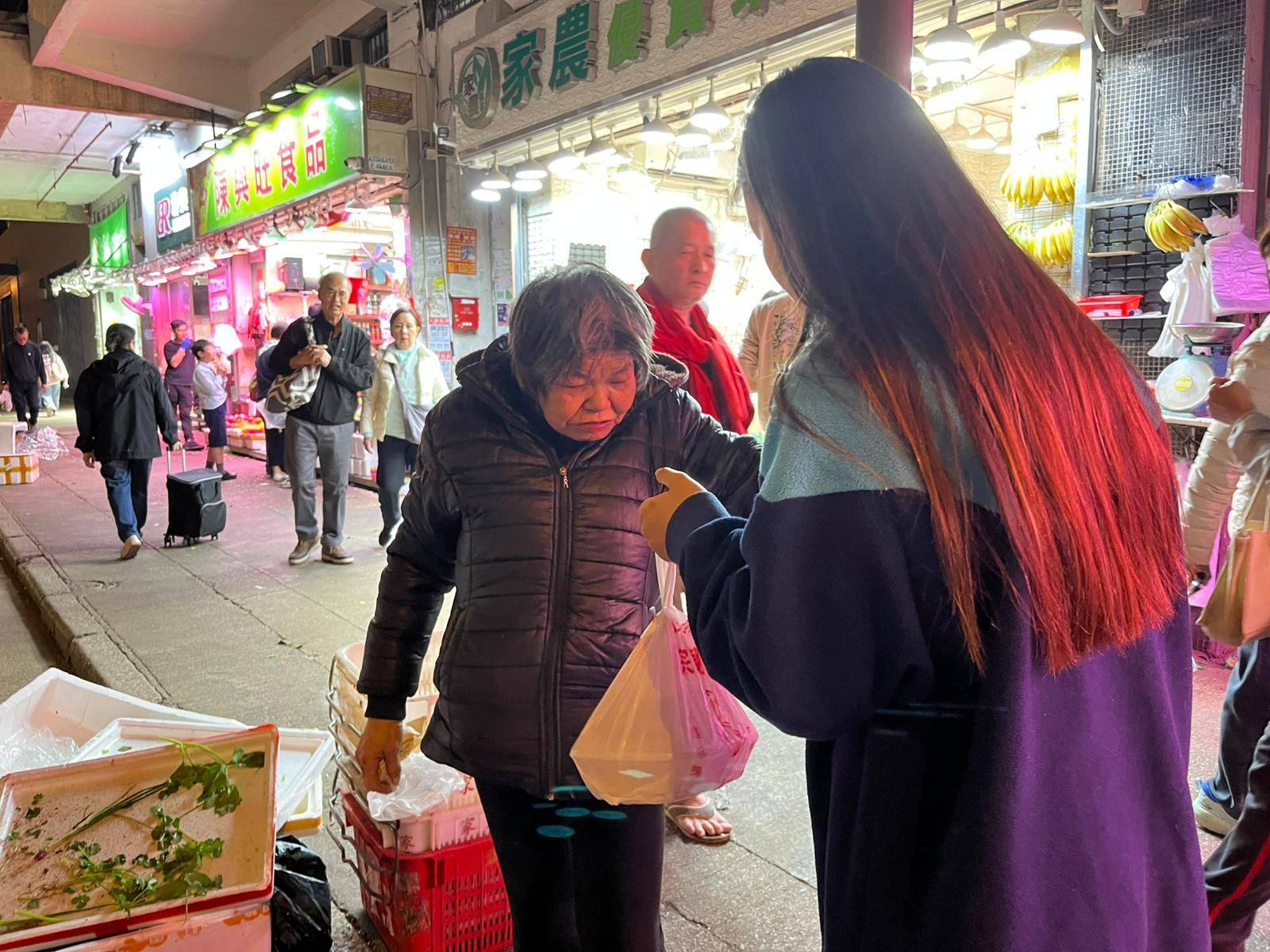 Belle* (right) walks around Hong Kong distributing hot meals to elderly people in need. Photo: Handout