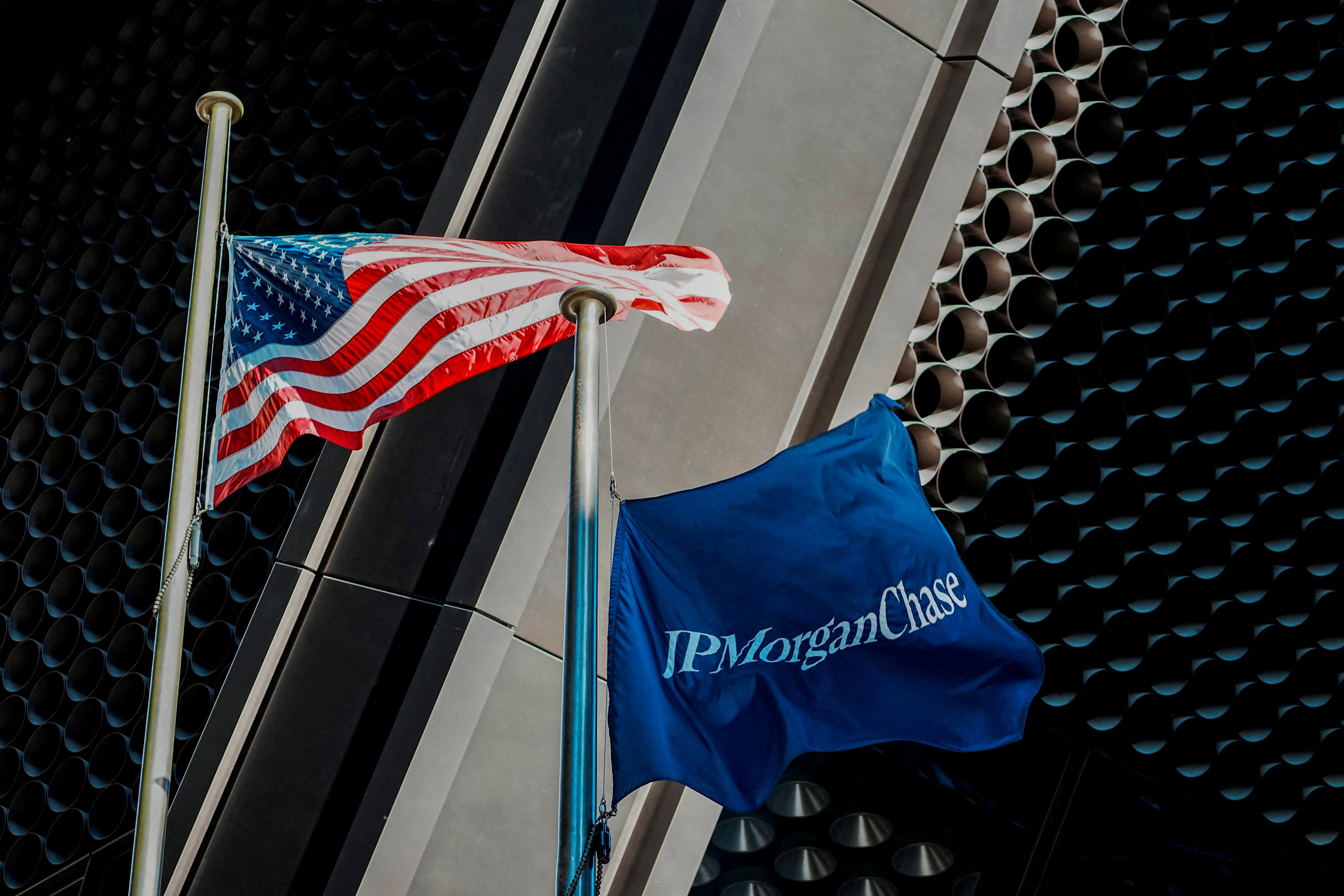 The US flag and a flag with the logo of JPMorgan Chase are flown at the firm’s new headquarters in New York in October 2025. Photo: Reuters