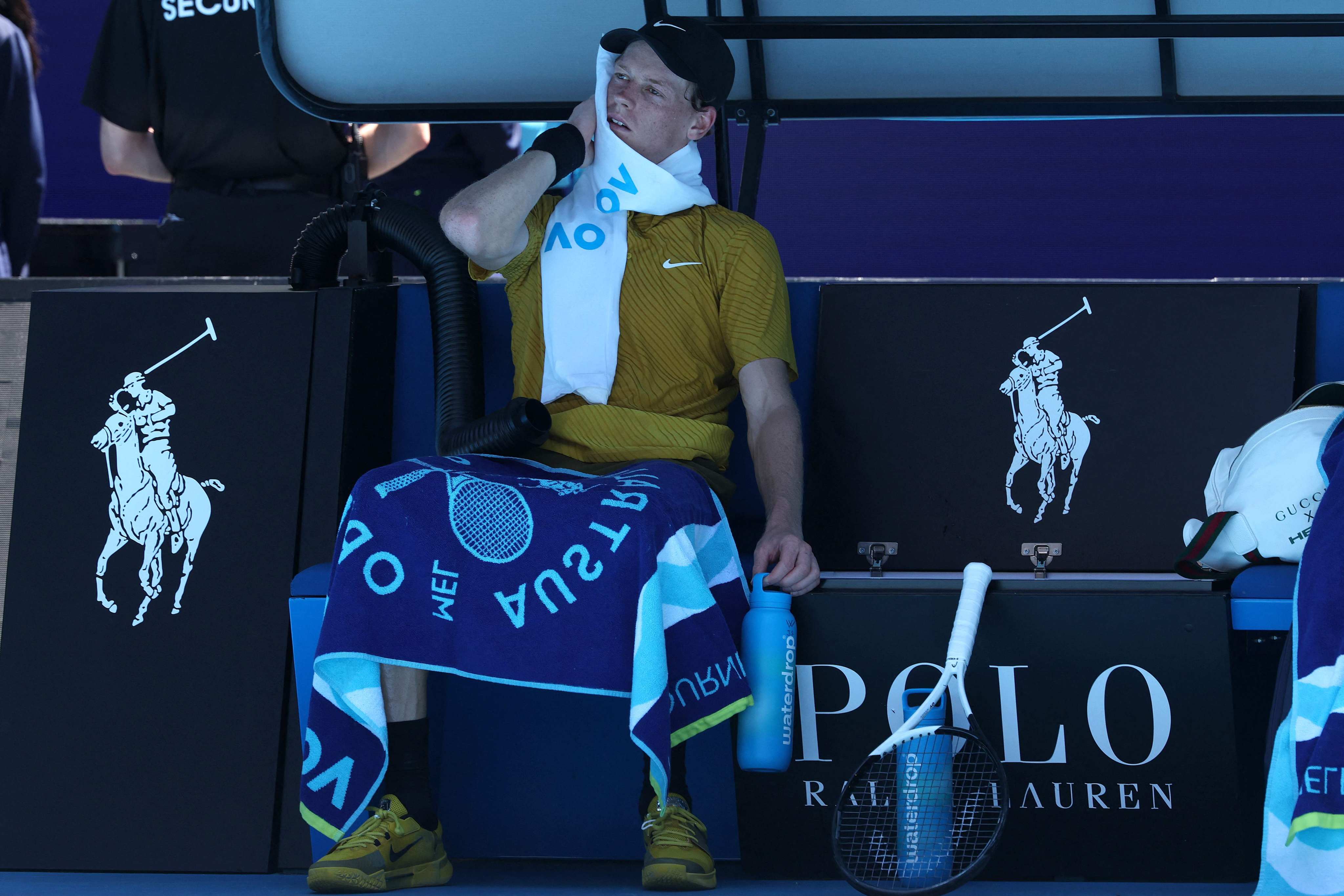 Jannik Sinner wipes his face between games against Eliot Spizzirri. Photo: AFP