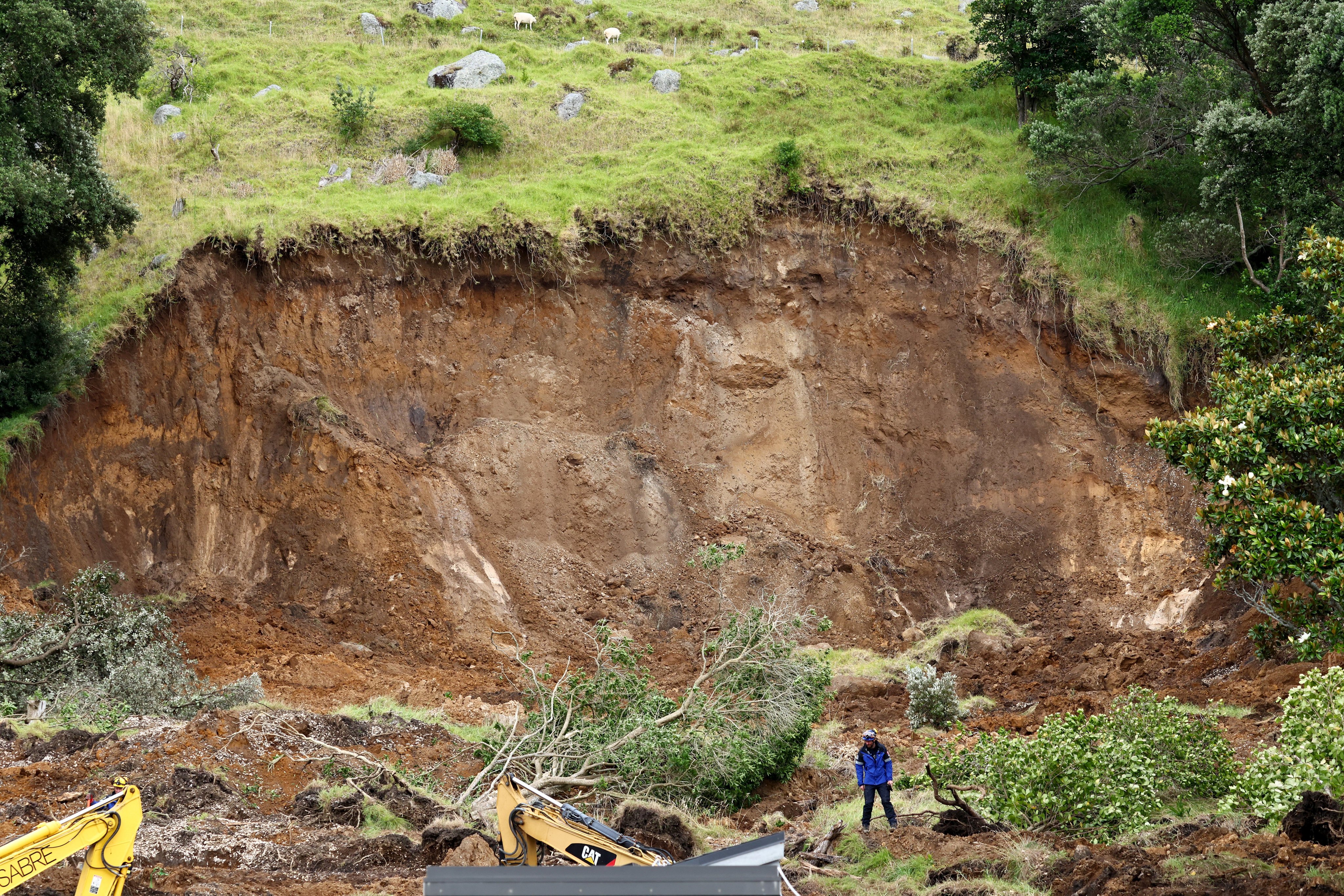 Rescuers work at the scene of a landslide in Mount Maunganui on Saturday . Photos: Reuters
