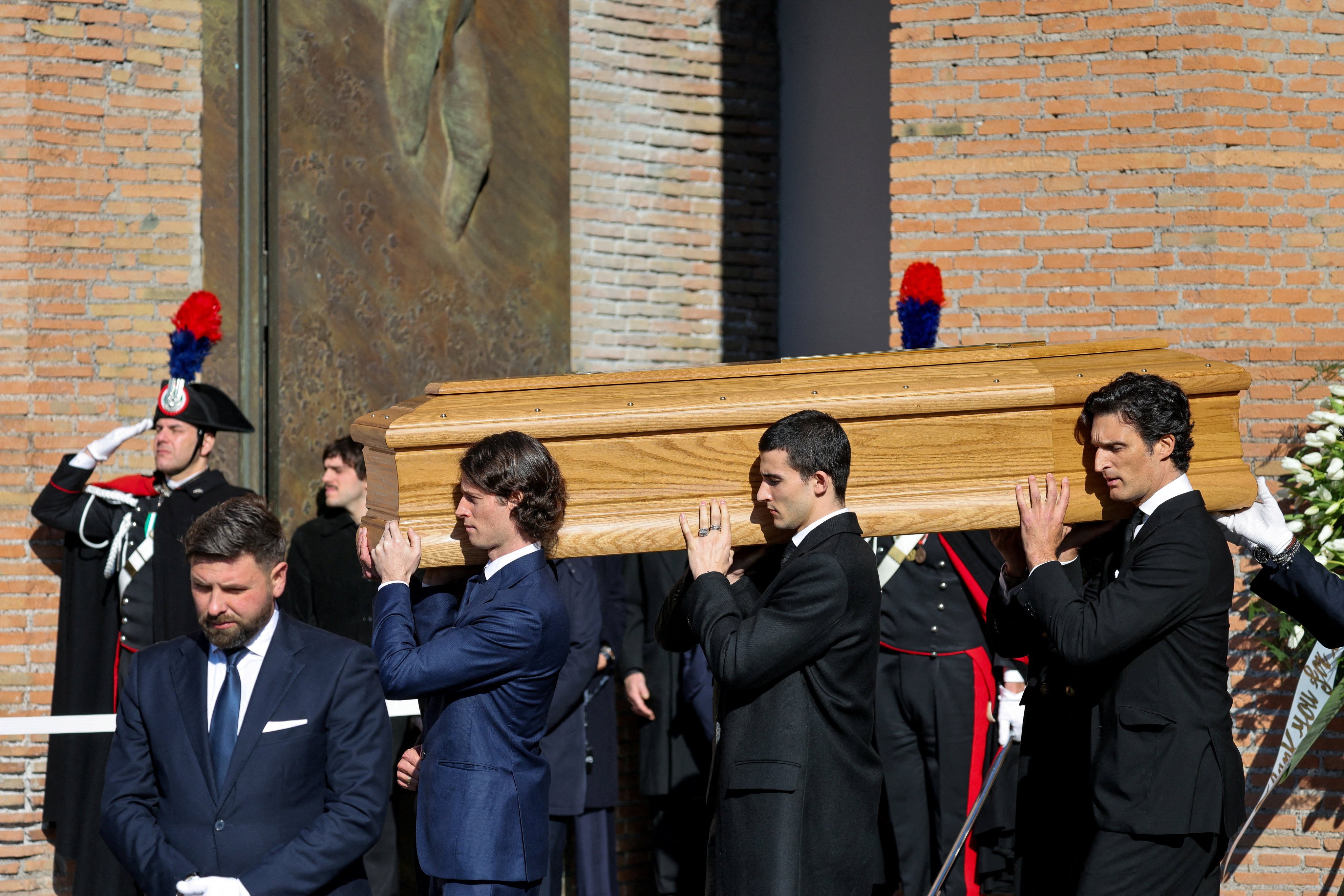 Anthony Souza, the godson of late fashion designer Valentino Garavani, and pallbearers carry the coffin of Valentino Garavani outside the Basilica of Saint Mary of the Angels and Martyrs in Rome on Friday. Photo: Reuters