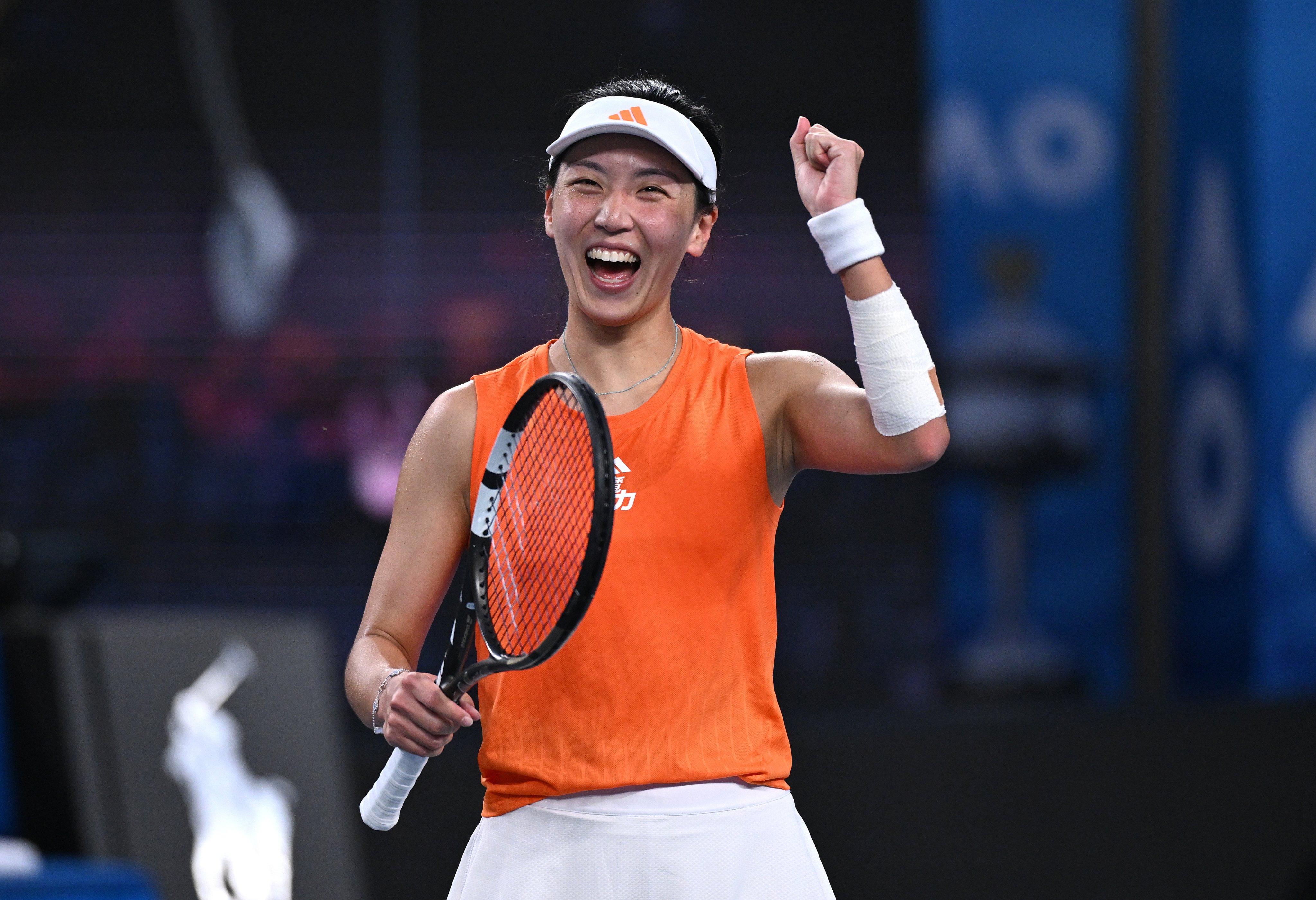 Wang Xinyu of China celebrates after winning her third-round match against Linda Noskova of the Czech Republic on Saturday. Photo: EPA