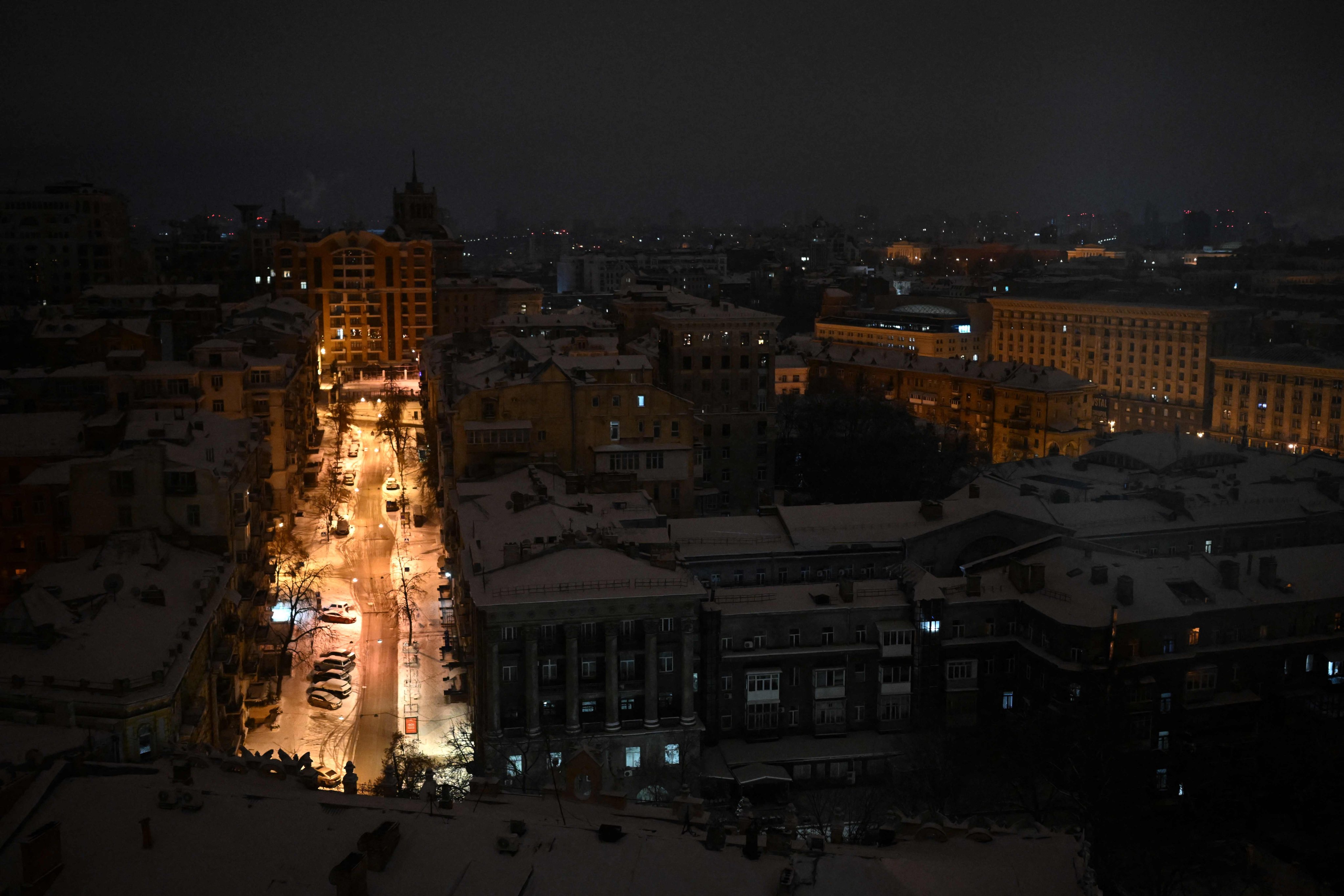 An illuminated street is seen during an air attack in central Kyiv on Saturday. Photo: AFP