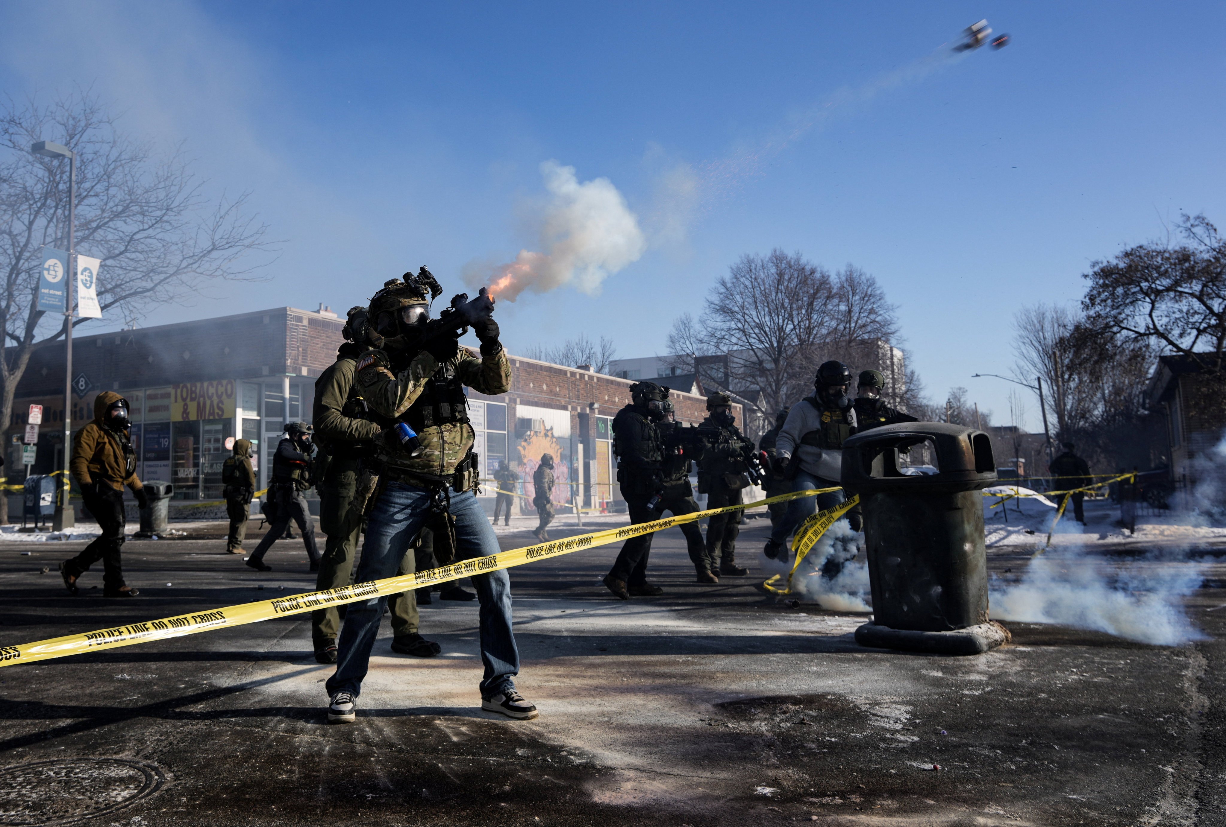 A federal agent shoots tear gas cannisters during scuffles at the scene of a shooting in Minneapolis, Minnesota, on Saturday. Photo: Reuters