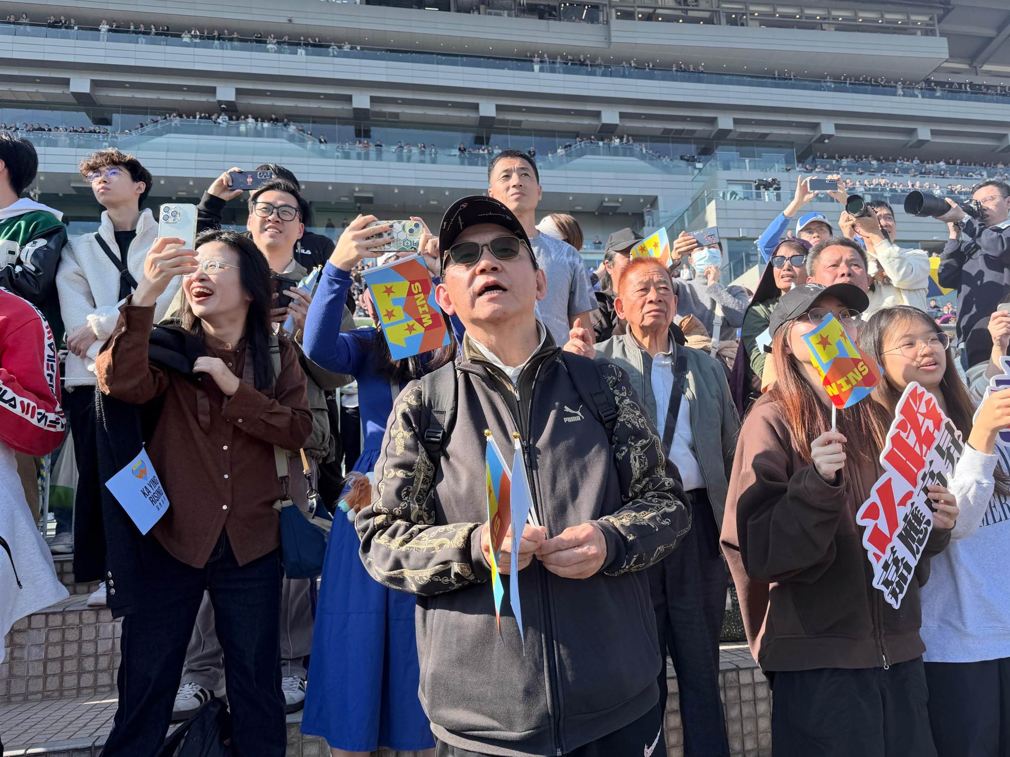 Loyal fan Daniel Tsui watches Ka Ying Rising cross the finish line far ahead. Photo: Stephy Zhang. Loyal fan Daniel Tsui watches Ka Ying Rising cross the finish line far ahead. Photo: Stephy Zhang.