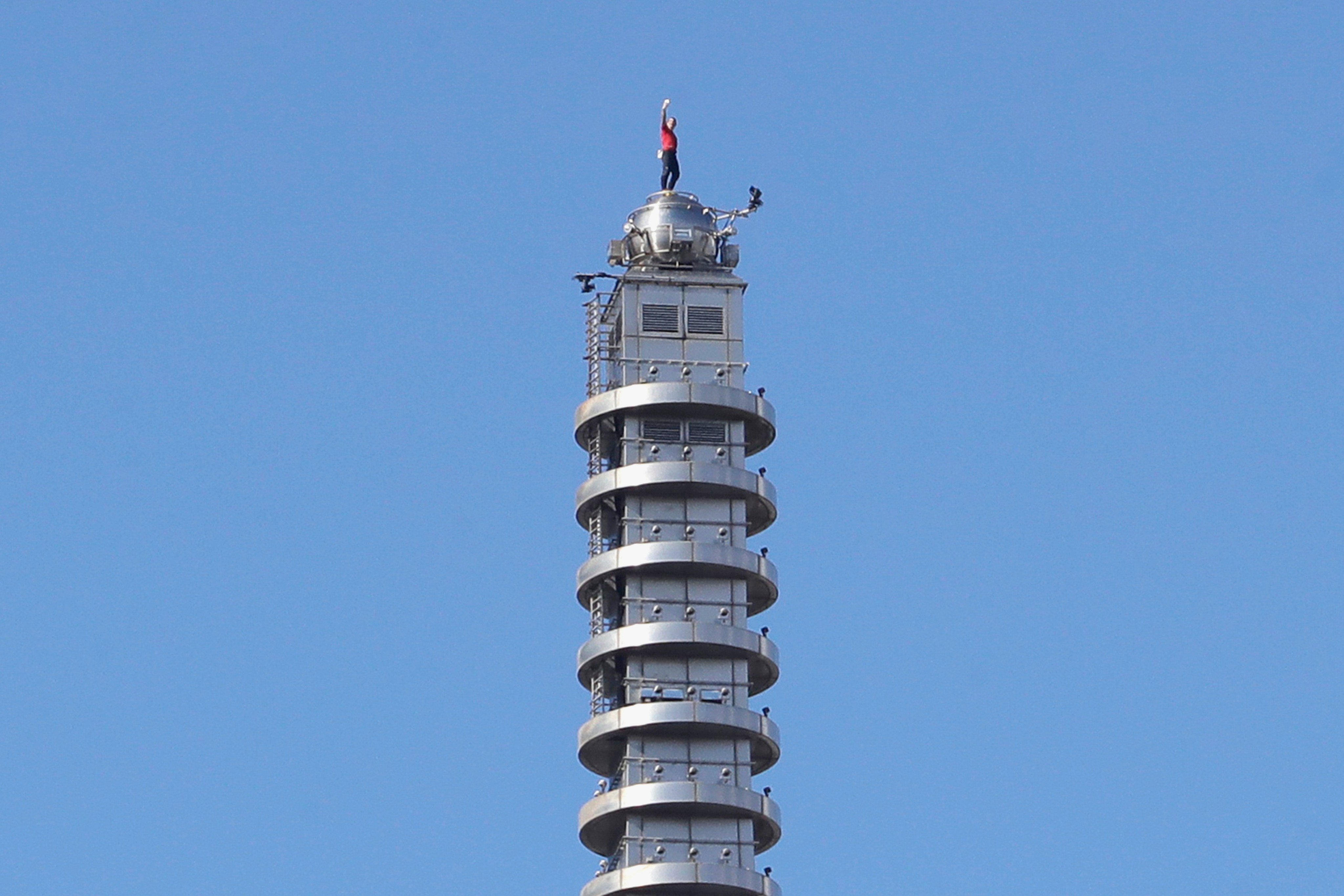 American rock climber Alex Honnold raises his fist after reaching the top of the Taipei 101 skyscraper on Sunday. Photo: AP