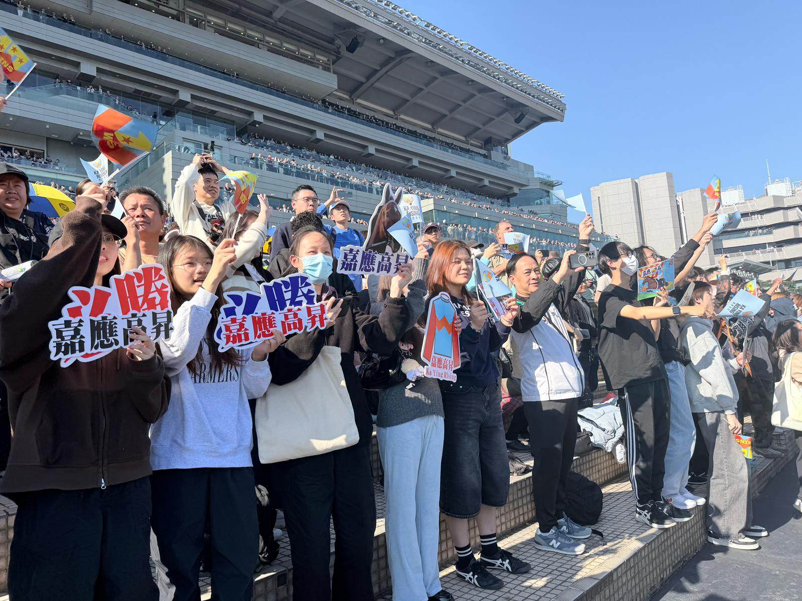 Fans gathered for the sixth race of the day, holding up homemade banners, paintings and flags in support. Photo: Stephy Zhang