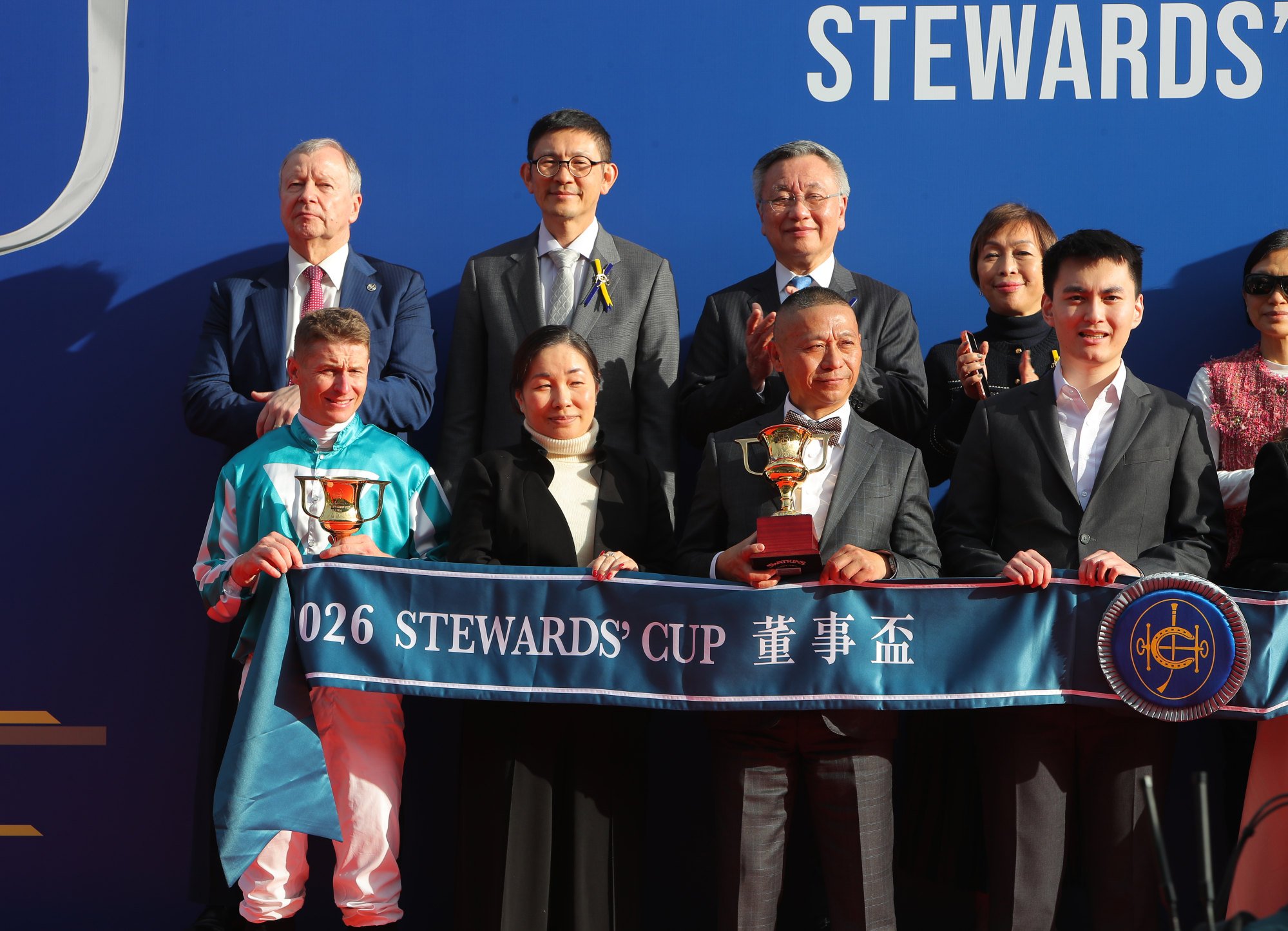 Jockey James McDonald and connections of Romantic Warrior celebrate. Jockey James McDonald and connections of Romantic Warrior celebrate.