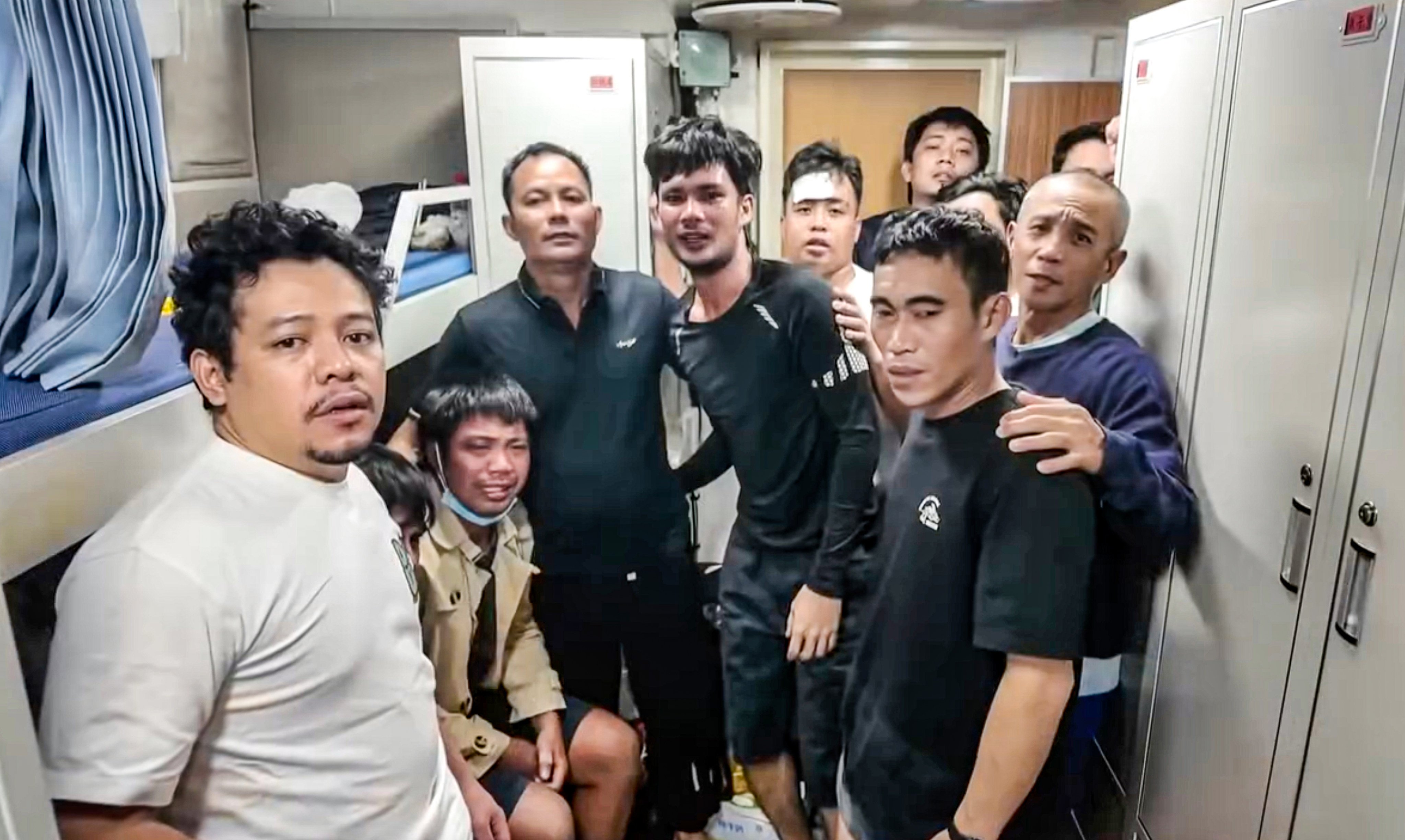 Surviving crew members of the capsized Devon Bay cargo ship reunite after their rescue by the China Coast Guard near Scarborough Shoal on Friday. Photo: Handout