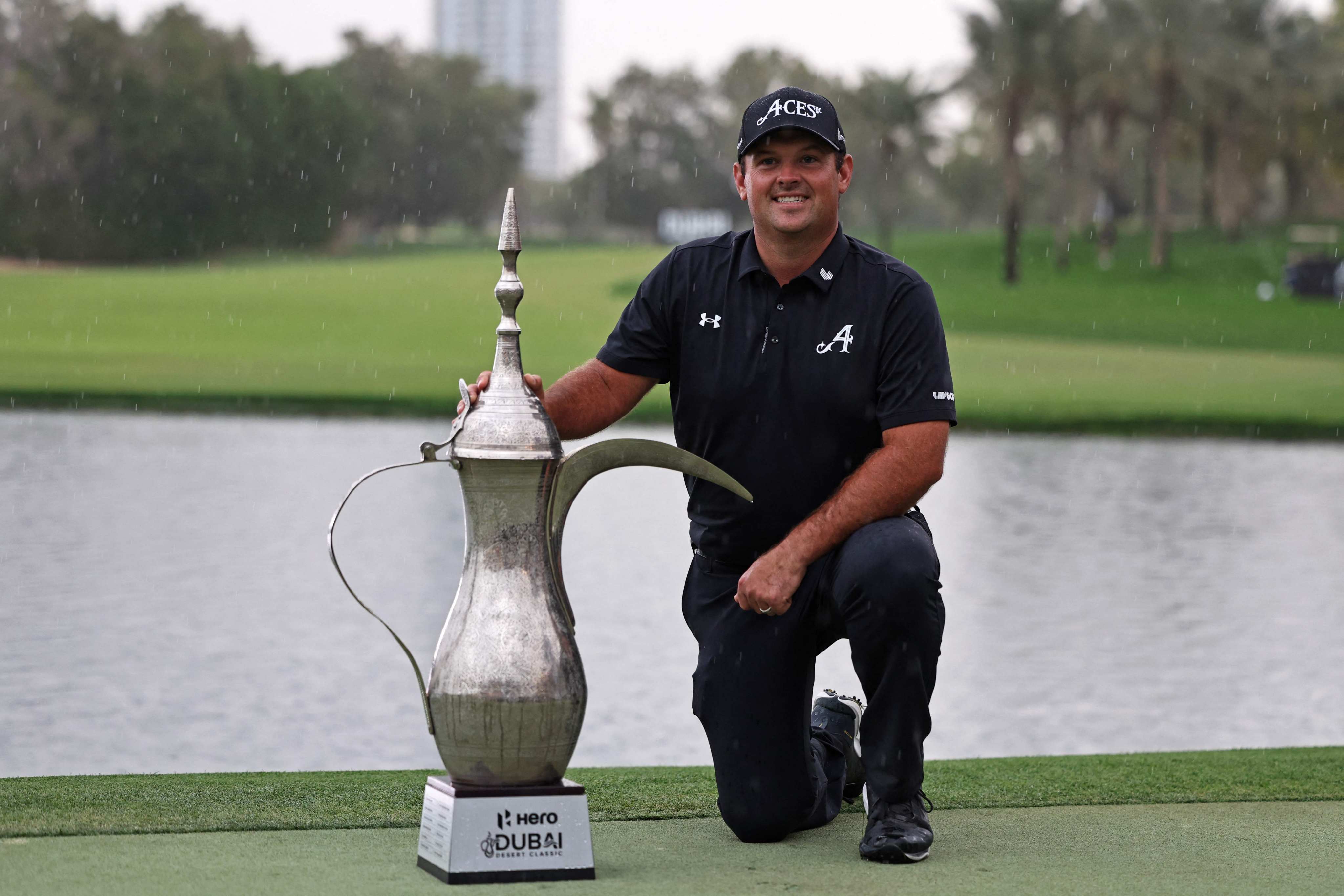 Patrick Reed poses with the trophy after winning the Dubai Desert Classic golf tournament. Photo: AFP