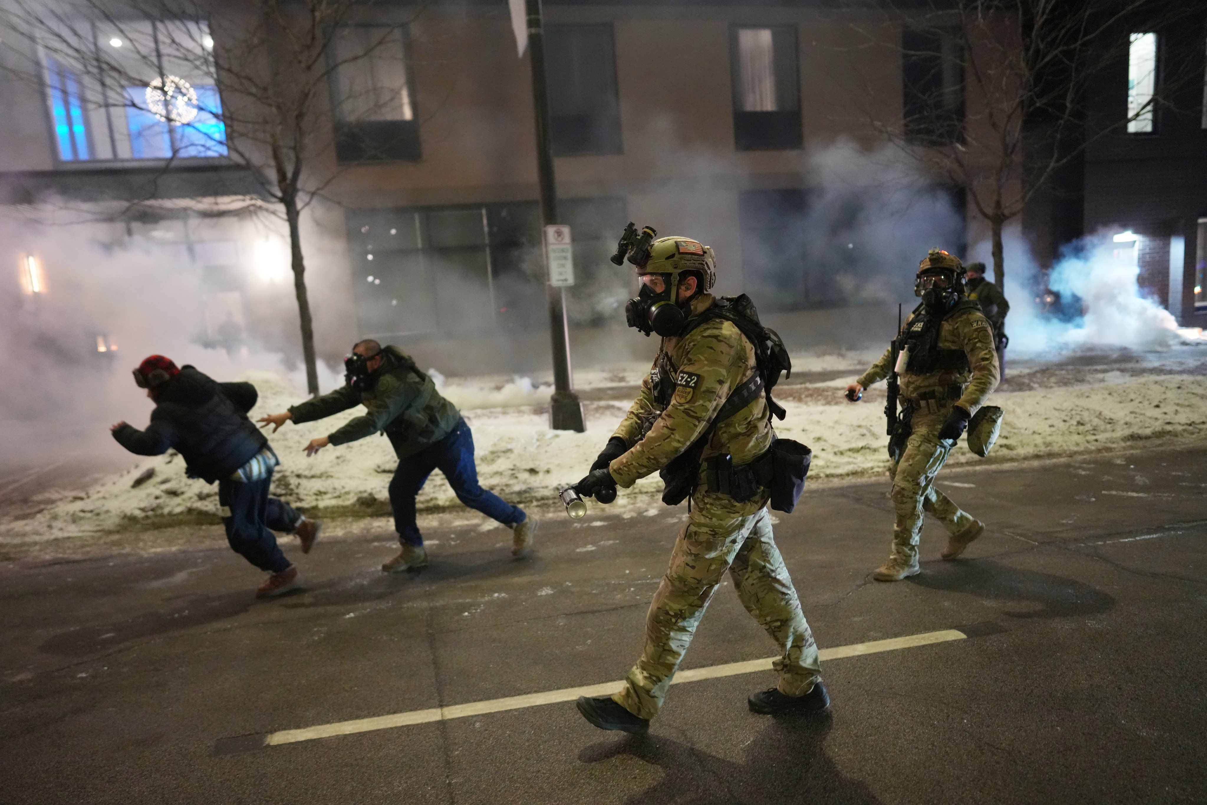 Federal agents try to clear demonstrators near a hotel, using tear gas during a demonstration in response to federal immigration enforcement operations in Minneapolis on January 25. Photo: AP