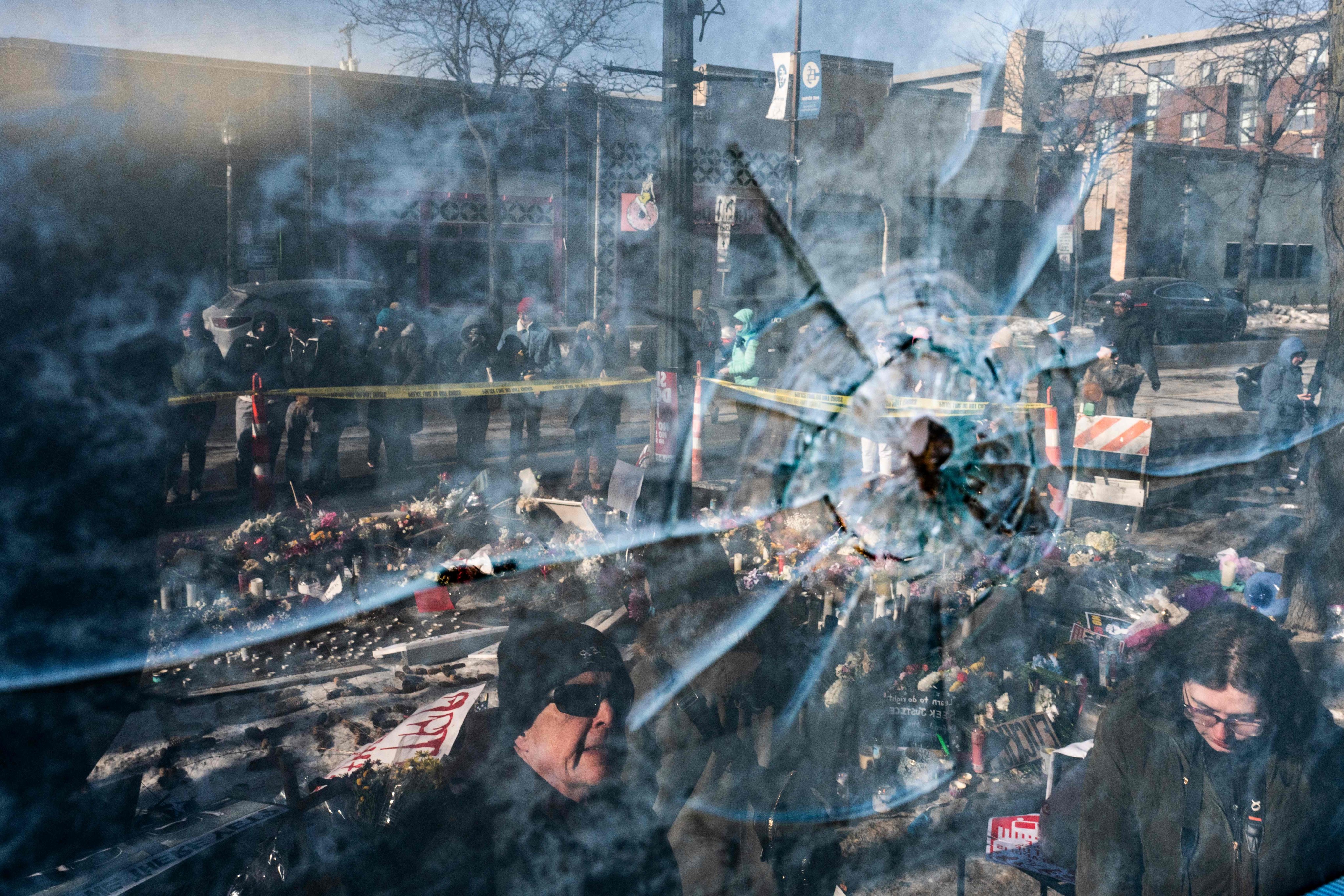 A gunshot perforation in a window pane near a makeshift memorial for Alex Pretti in Minneapolis. Photo: AFP