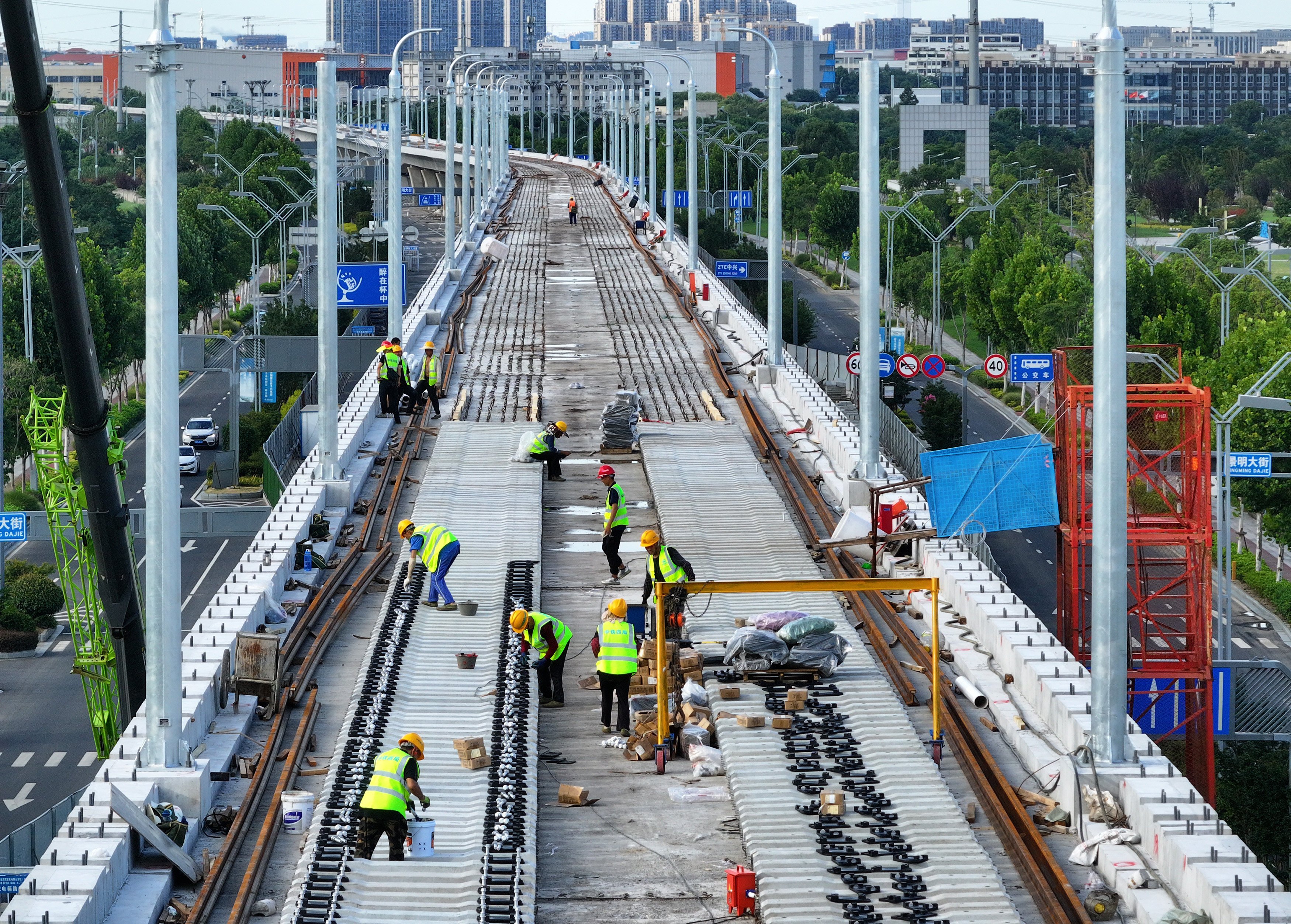 Workers lay track at a construction site in China’s Jiangsu province. Photo: Getty Images