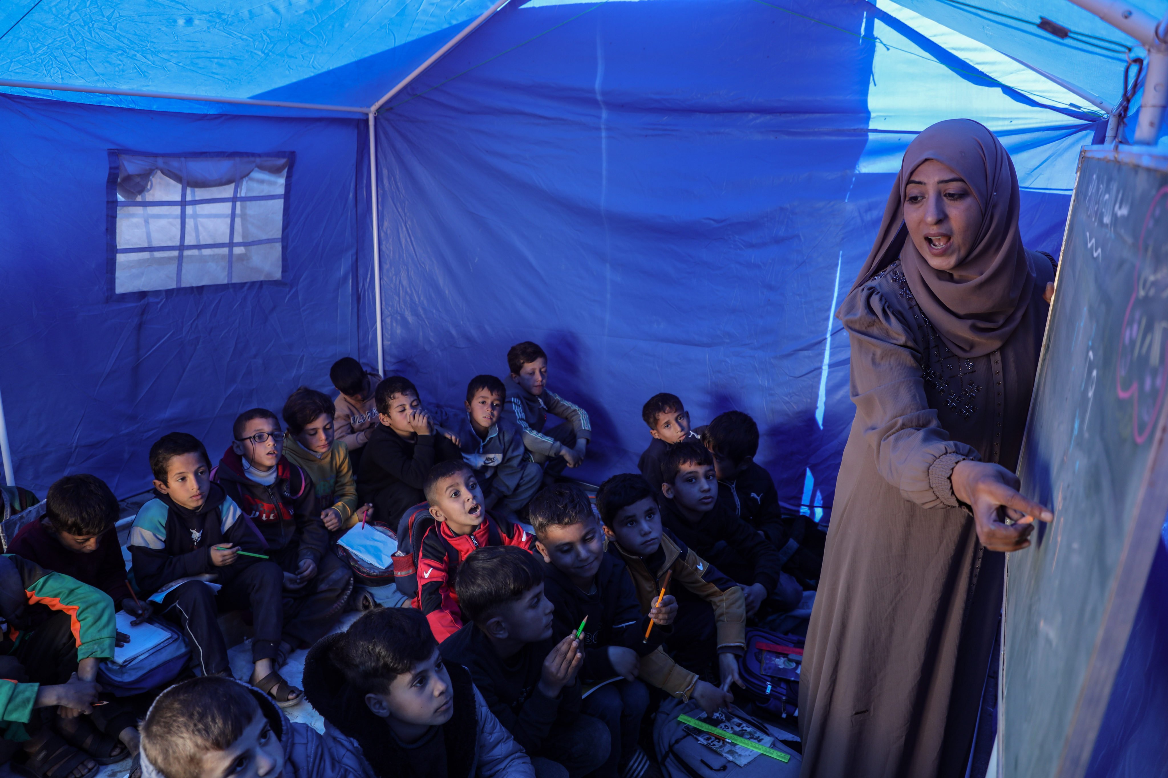 Students attend a class at Al-Shamal Educational School, located just 100 metres from the “Yellow Line” in Jabalia Refugee Camp on January 12. Photo: Xinhua