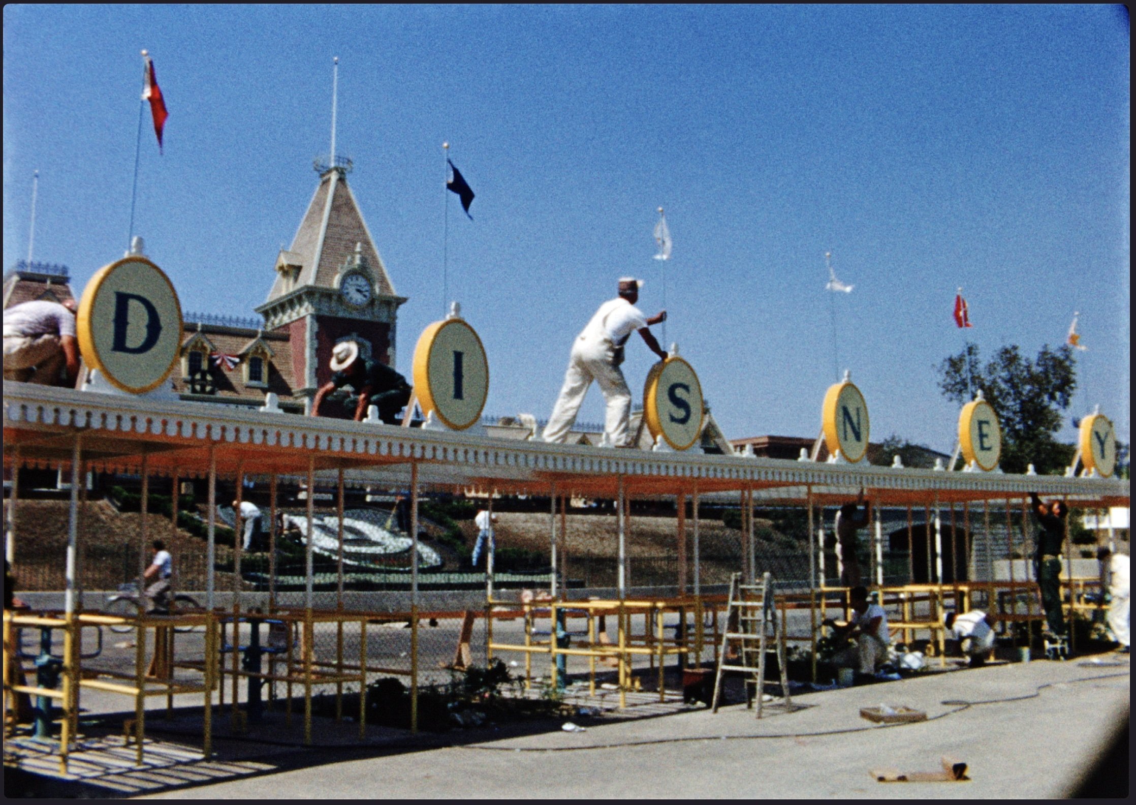 Workers construct the front gates of California’s Disneyland in a still from Disneyland Handcrafted, a new documentary on Disney+. Photo: TNS