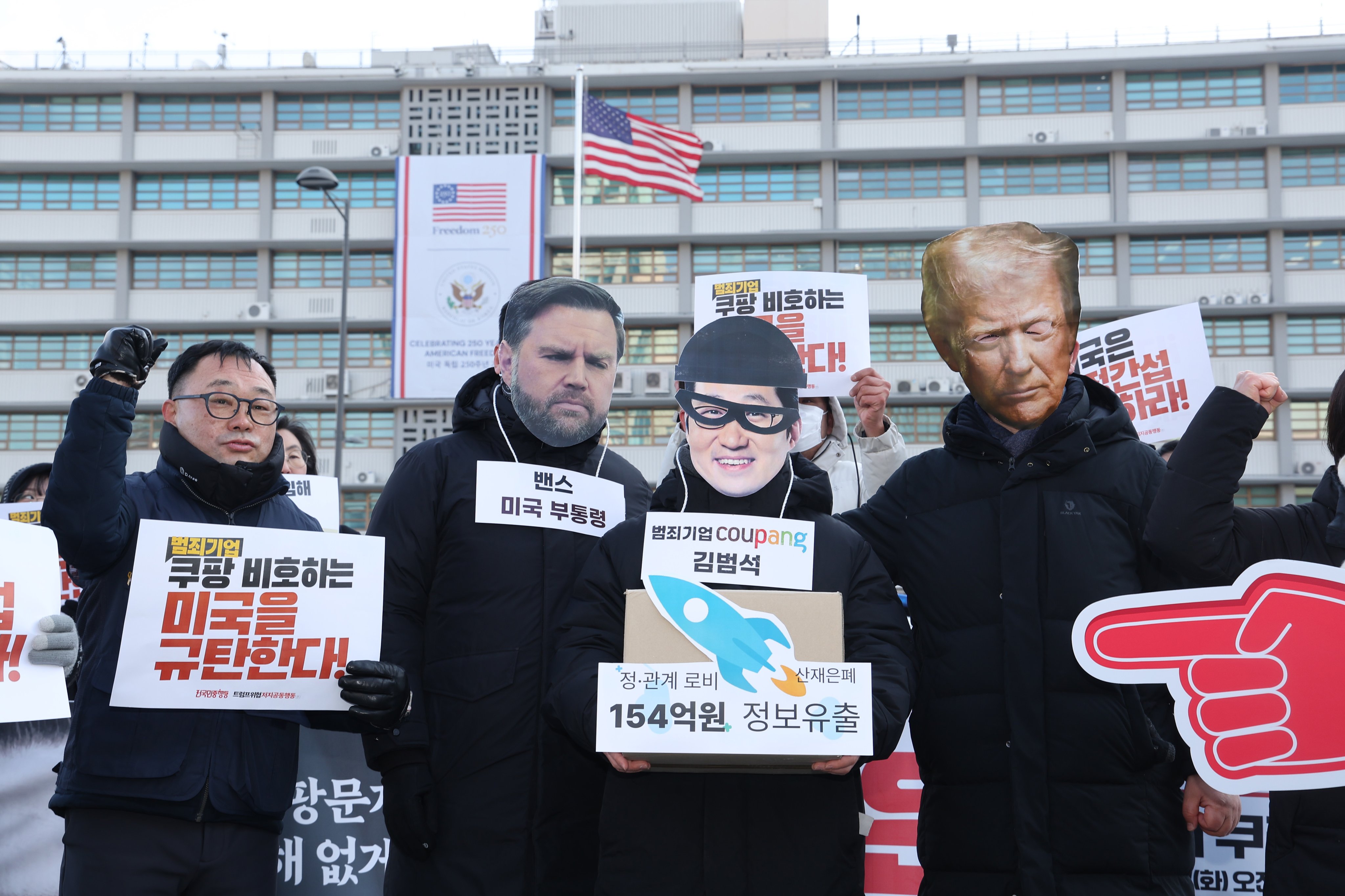 Protestors don masks of US President Donald Trump and Vice President JD Vance at an anti-Trump rally outside the US Embassy in Seoul on Tuesday, after the president announced a tariff hike. Photo: Yonhap/EPA