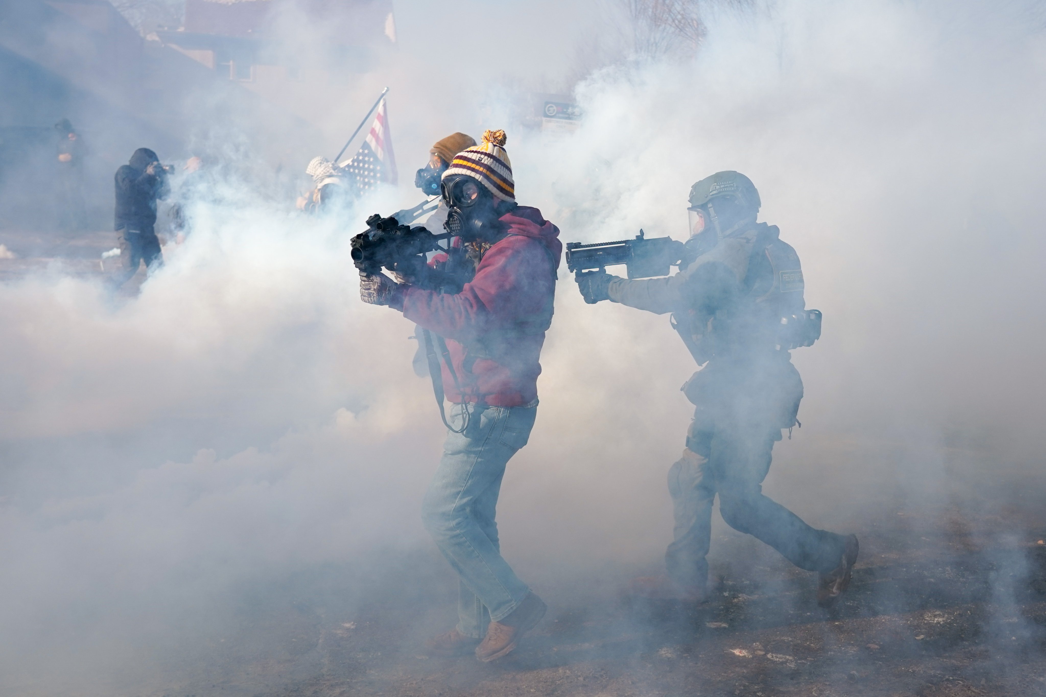 Federal officers move on protesters during a confrontation after ICE agents shot a man several times while they were trying to detain him in Minneapolis, Minnesota on January 24. Photo: EPA