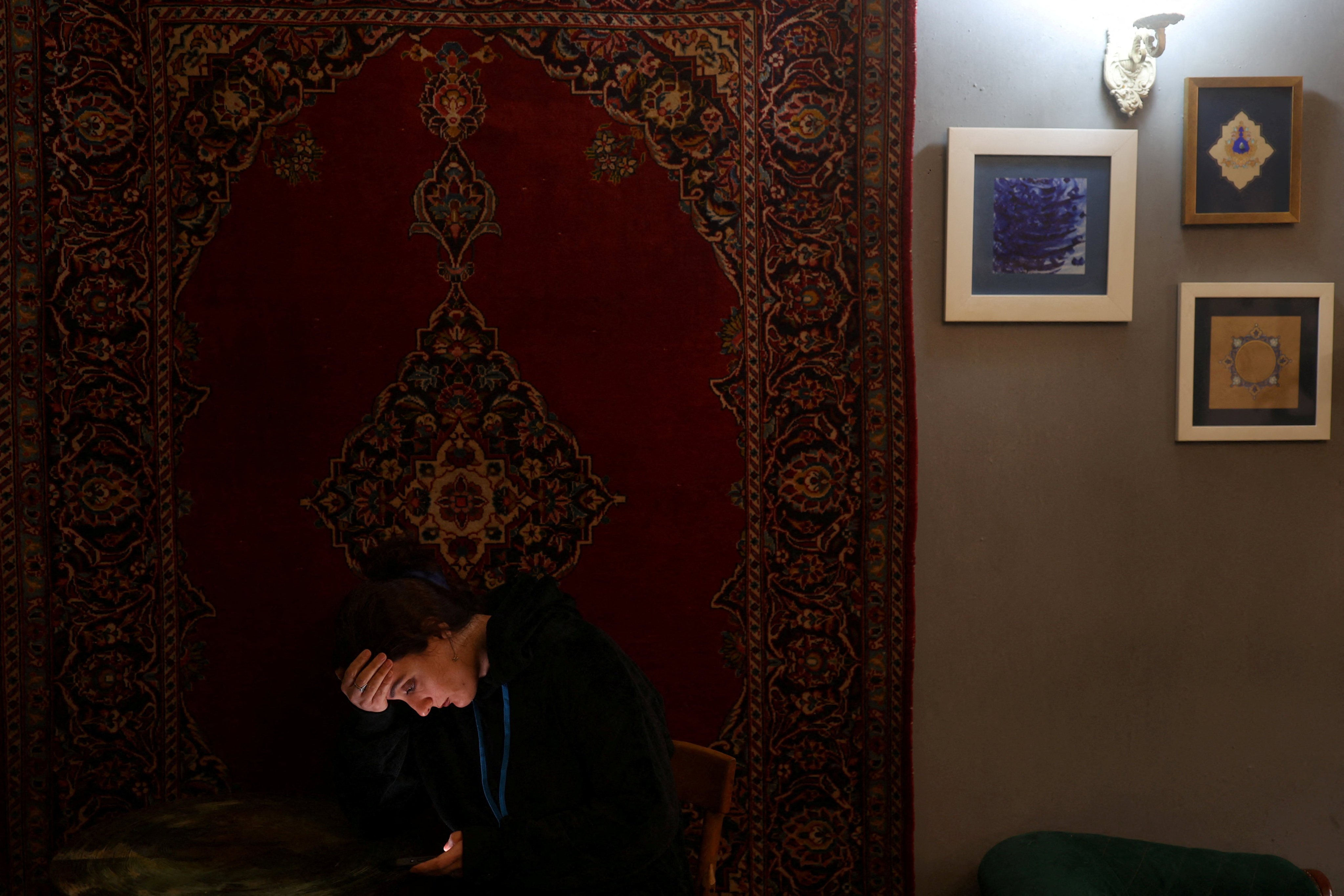 An Iranian woman, Samaneh, tries to connect to the internet to check on her visa status for her migration process, after a nationwide internet shutdown since January 8, 2026, following Iran’s protests, in Tehran, Iran. Photo: Reuters
